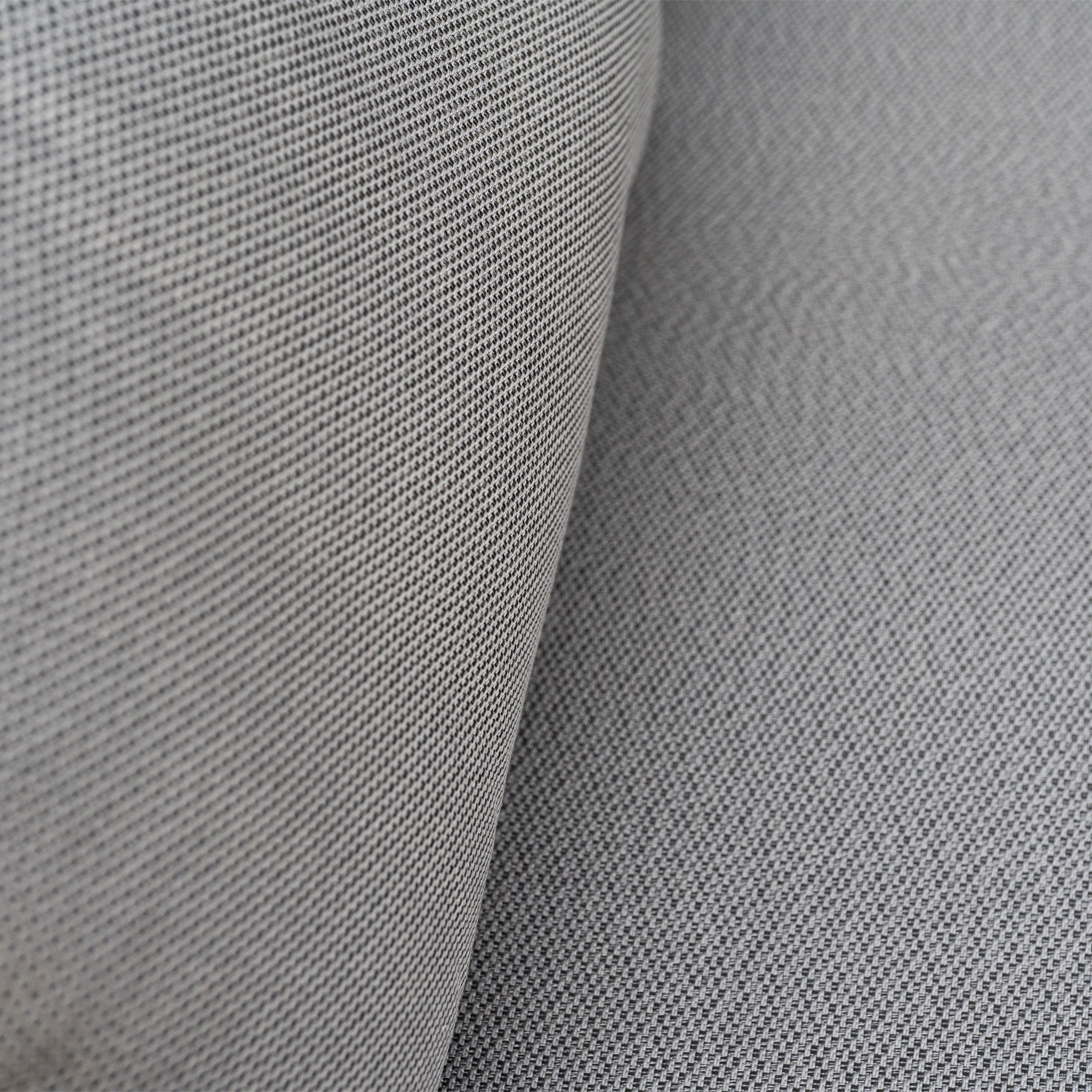 Close-up of light grey textured fabric upholstery, part of the Pello U-Shape Corner Sofa Set with Altura Rising Table in Grey.