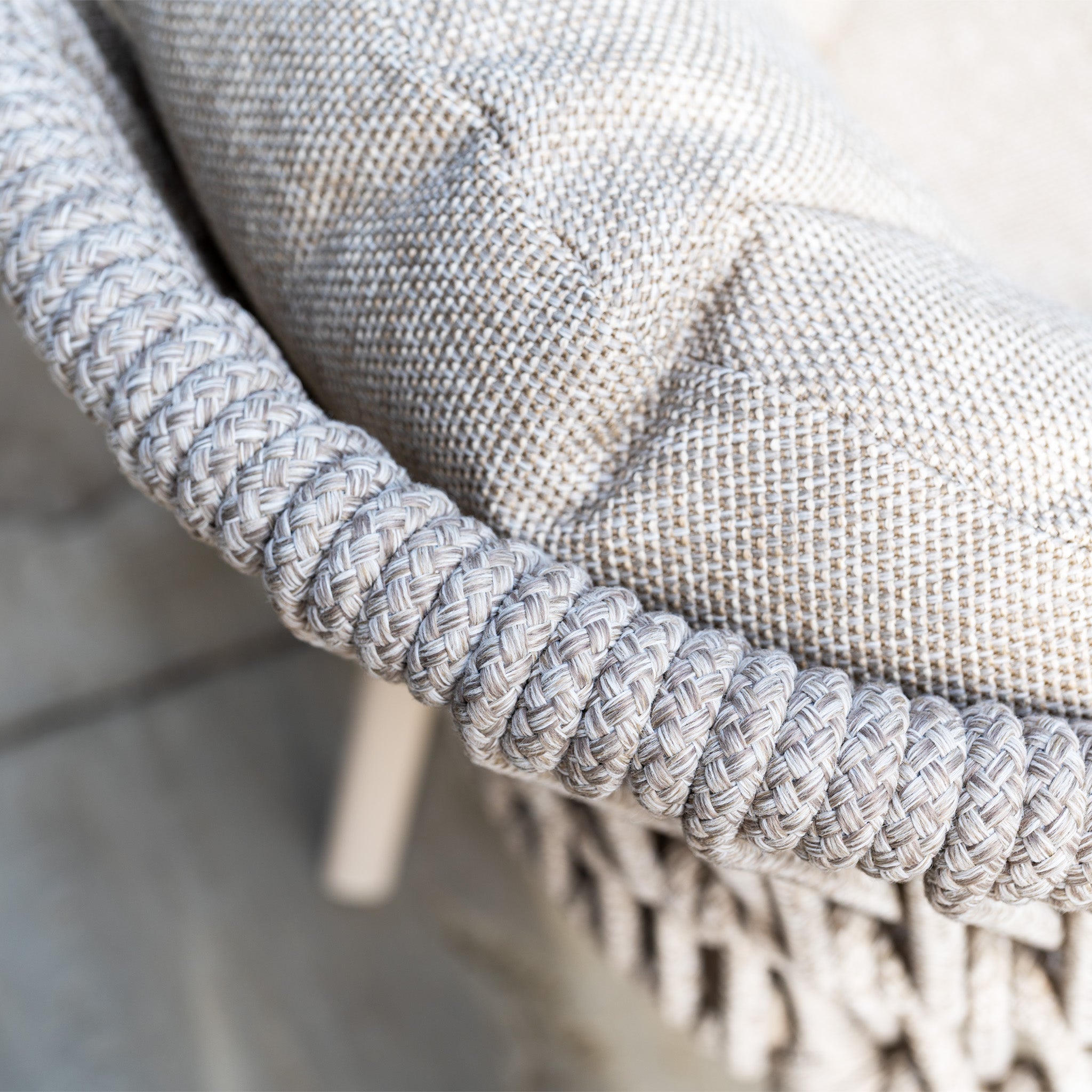 Close-up of the Pello 8 Seat Oval Dining Set with Albatross Extending Table in Fawn—showcasing its woven, textured light gray chairs with braided edging for an elegant and durable garden furniture look.