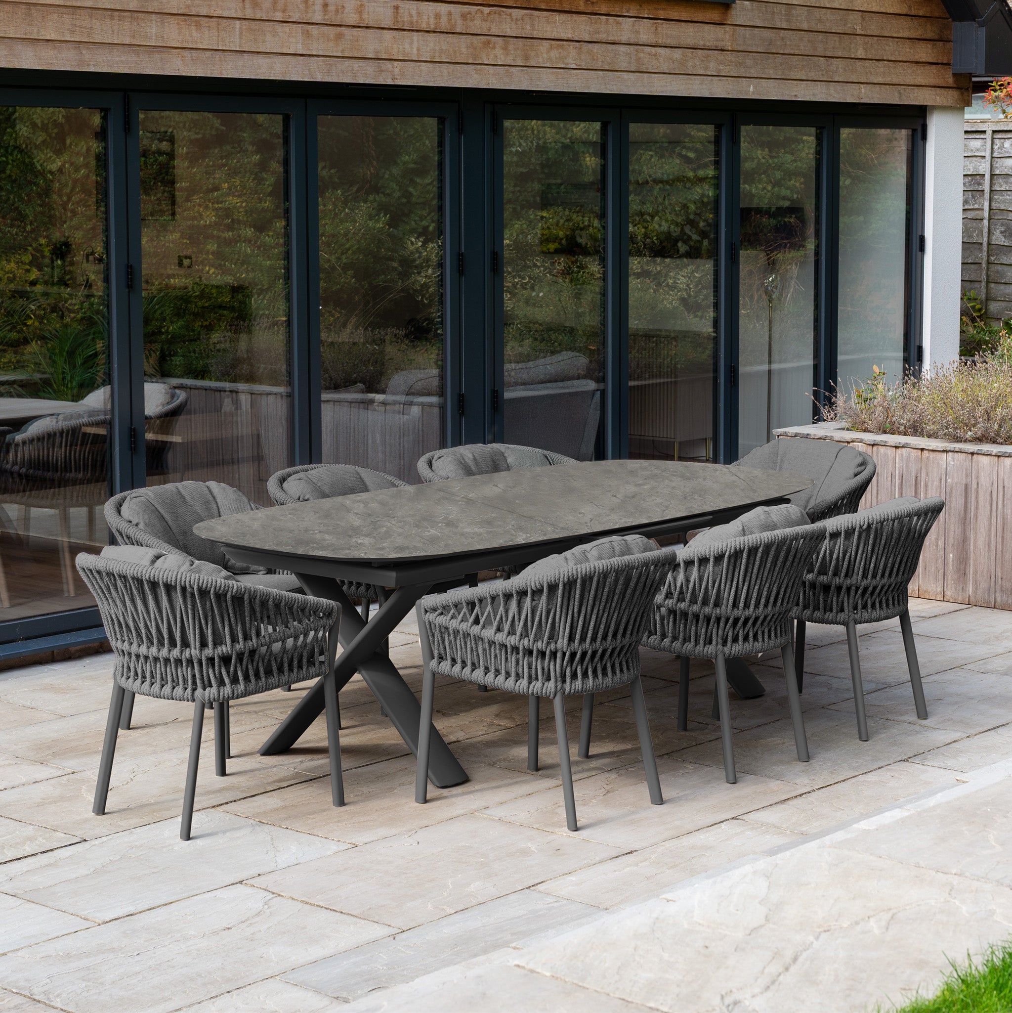 The Pello 8 Seat Oval Dining Set with Albatross Extending Table in Grey features eight stylish chairs, perfect for alfresco gatherings on your patio.