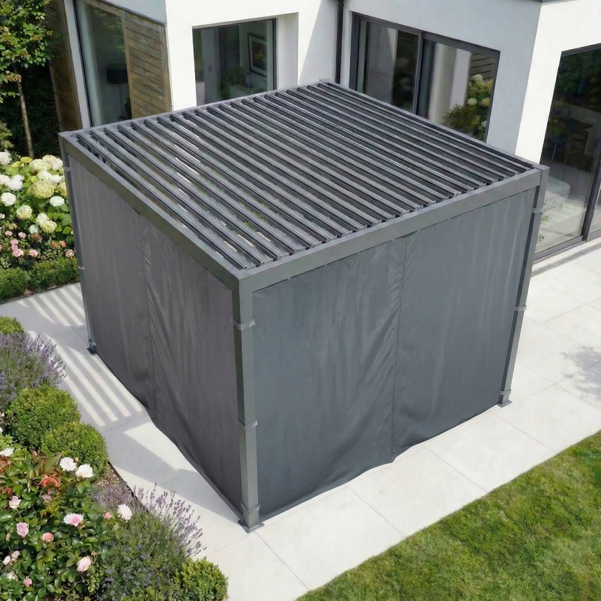 The PergoSTET Side Curtains for Lite and Lite Neo 3m x 3m Square Pergola in Grey provide weather-resistant coverage with closed side panels, perfect for a modern patio beside a contemporary house and garden.