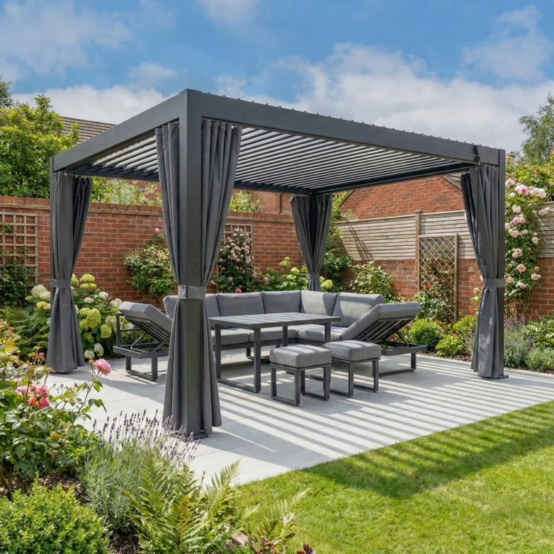 The PergoSTET Side Curtains for Lite and Lite Neo 3m x 4m Rectangular Pergola in Grey add privacy and style to a modern pergola with gray outdoor seating, surrounded by flowers and brick fences in a lush garden.
