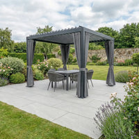 PergoSTET Side Curtains for Lite and Lite Neo 3m x 3m Square Pergola in Grey create a stylish patio setup, paired with a dining set and surrounded by green lawn and blooming garden.