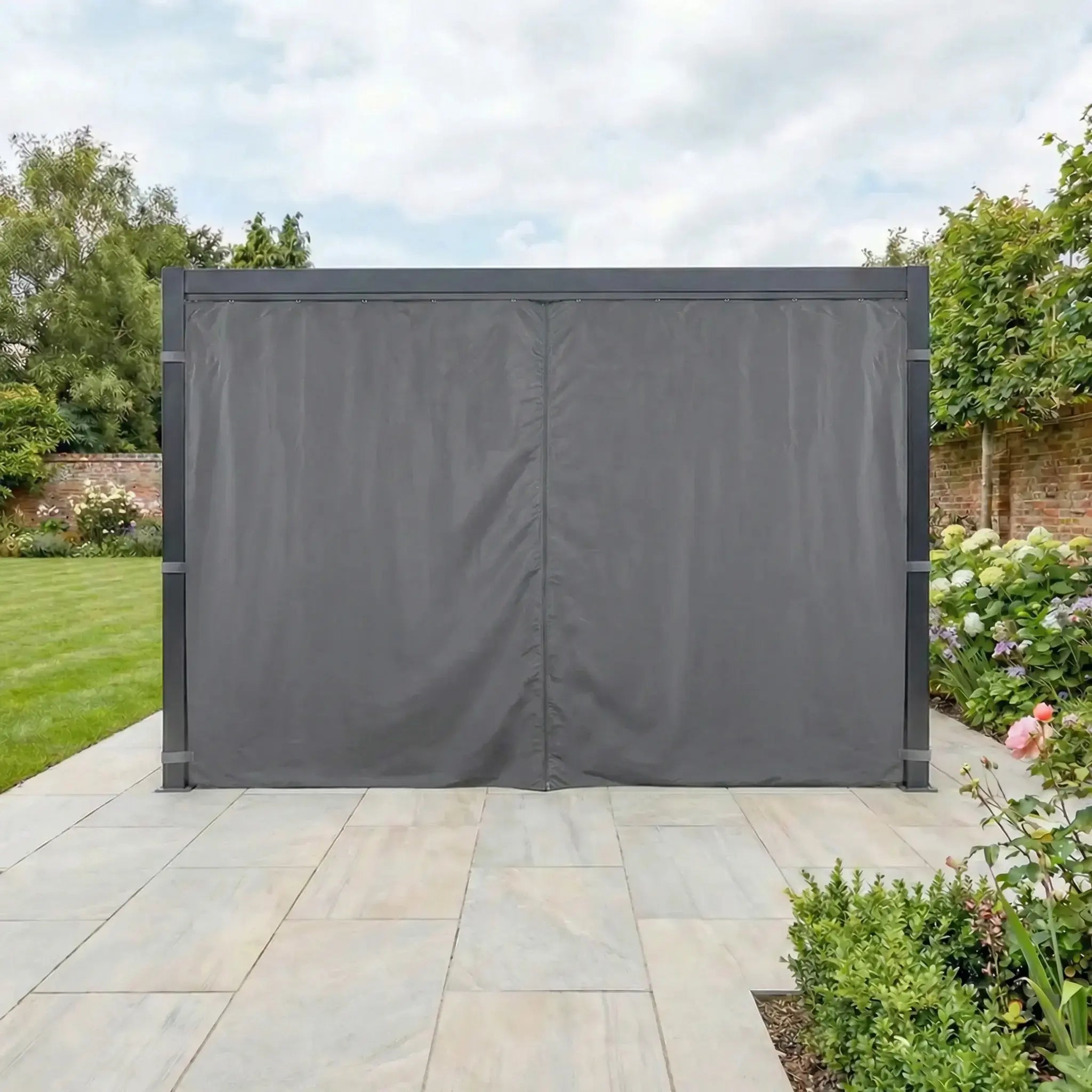 The PergoSTET Side Curtains for Lite and Lite Neo 3m x 4m Rectangular Pergola in Grey provide a stylish privacy shade on a tiled patio, creating a sheltered outdoor space in your landscaped garden.