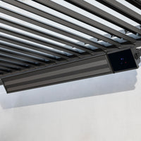 The PergoSTET Premium Wifi & Bluetooth Heater in Black is mounted beneath a slatted metal ceiling on a white wall, ideal for outdoor heating and perfect for pergolas from Harbour Lifestyle.
