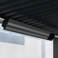 The PergoSTET 2400W Wifi & Bluetooth Heater in Black from Harbour Lifestyle is ceiling-mounted under a dark metal roof above a white wall—delivering stylish, smart outdoor heating ideal for pergola setups.