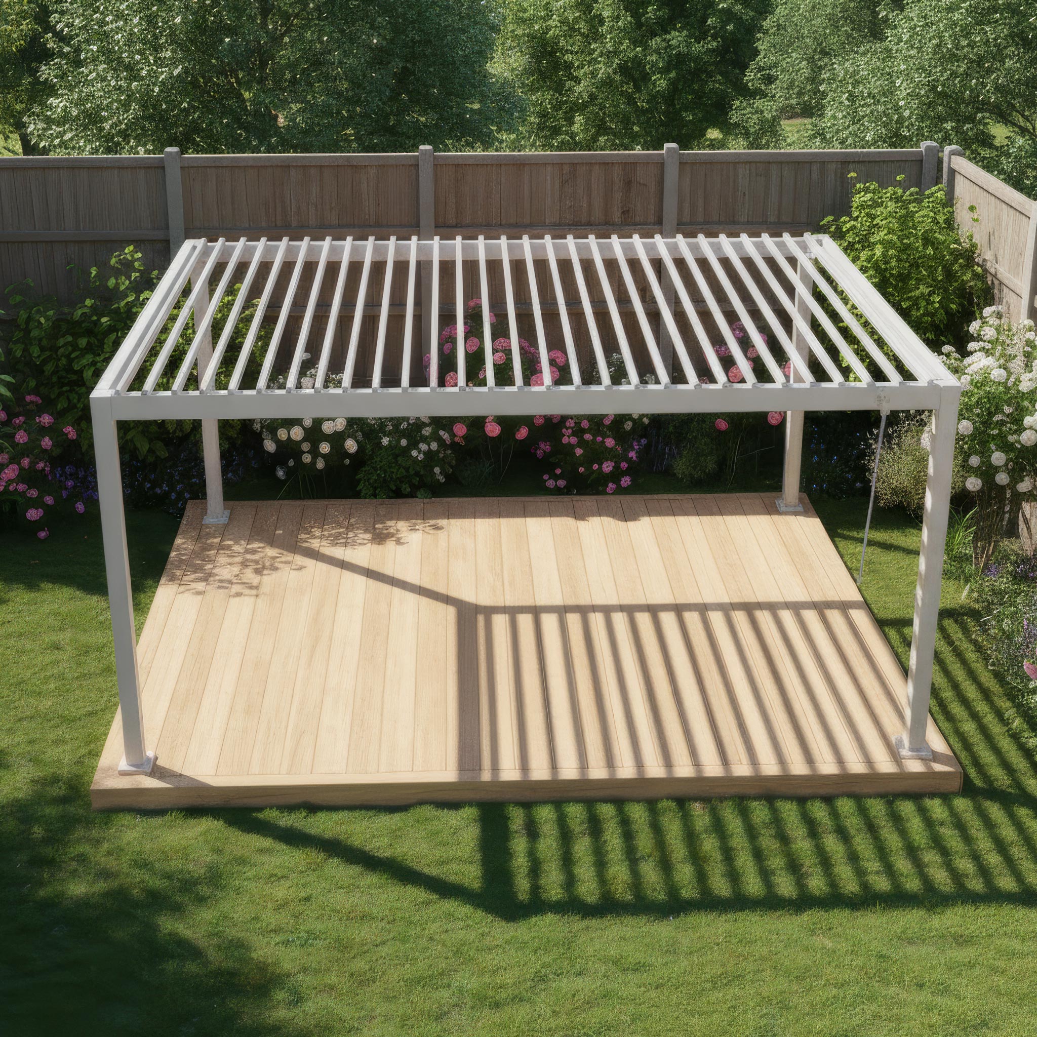 The PergoSTET Lite 3m x 4m Metal Rectangular Pergola in Latte provides stylish outdoor shade on a wooden deck, surrounded by green grass and flowering plants.