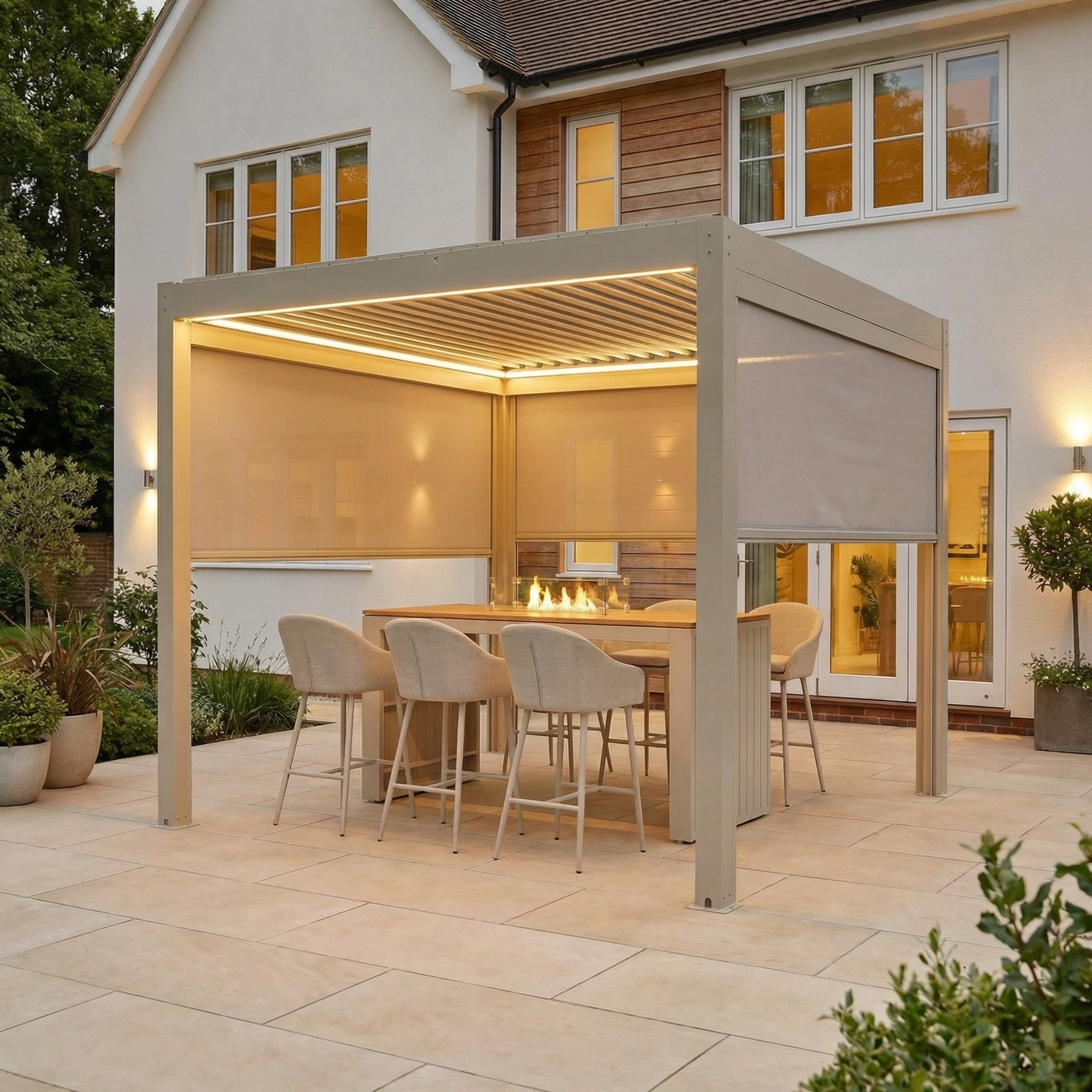 Modern outdoor dining area features the PergoSTET Plus 3m x 3m Square Pergola with 3 manual side blinds, integrated LED lighting in Latte, a table, chairs, fire feature, and textilene blinds on the patio.
