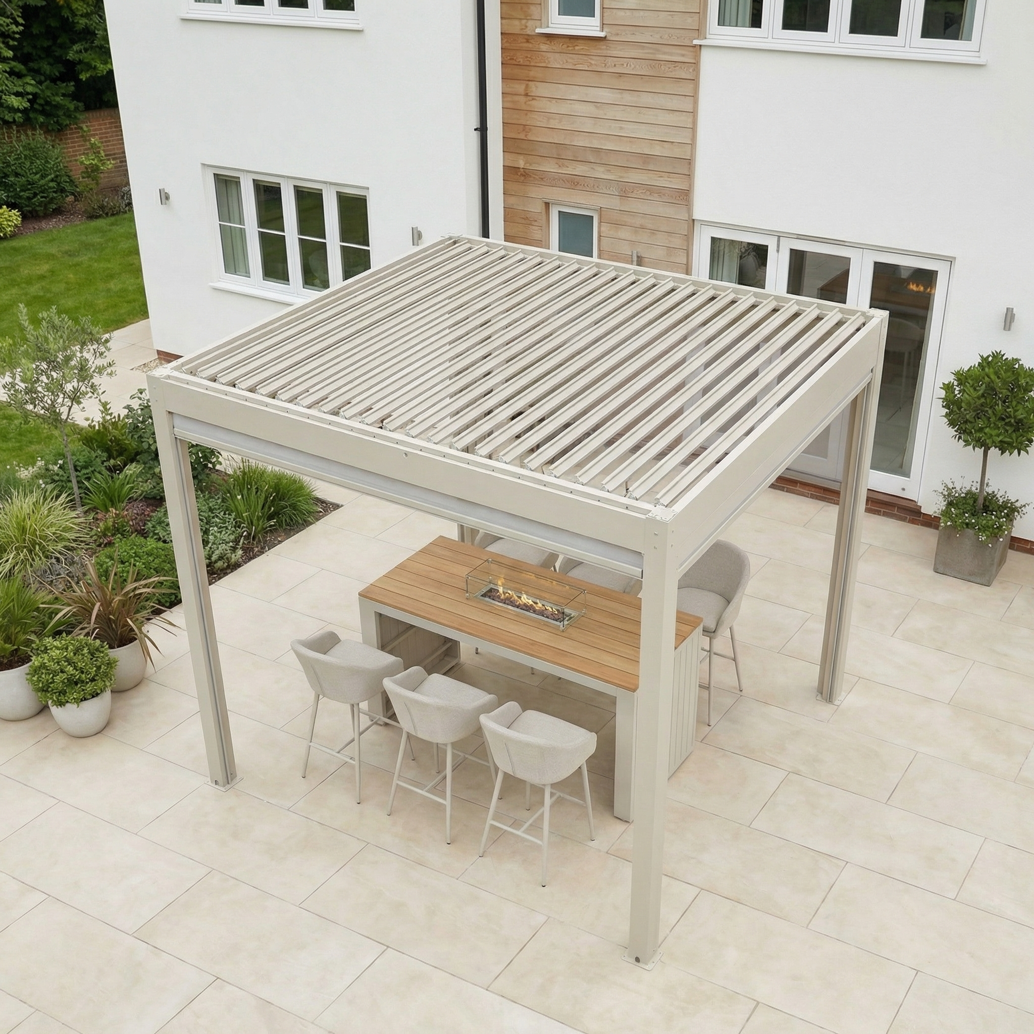 Modern patio featuring the PergoSTET Plus 3m x 3m Square Pergola with 3 manual side blinds and LED lighting in Latte, a dining table, six chairs, and potted plants on a tiled terrace.
