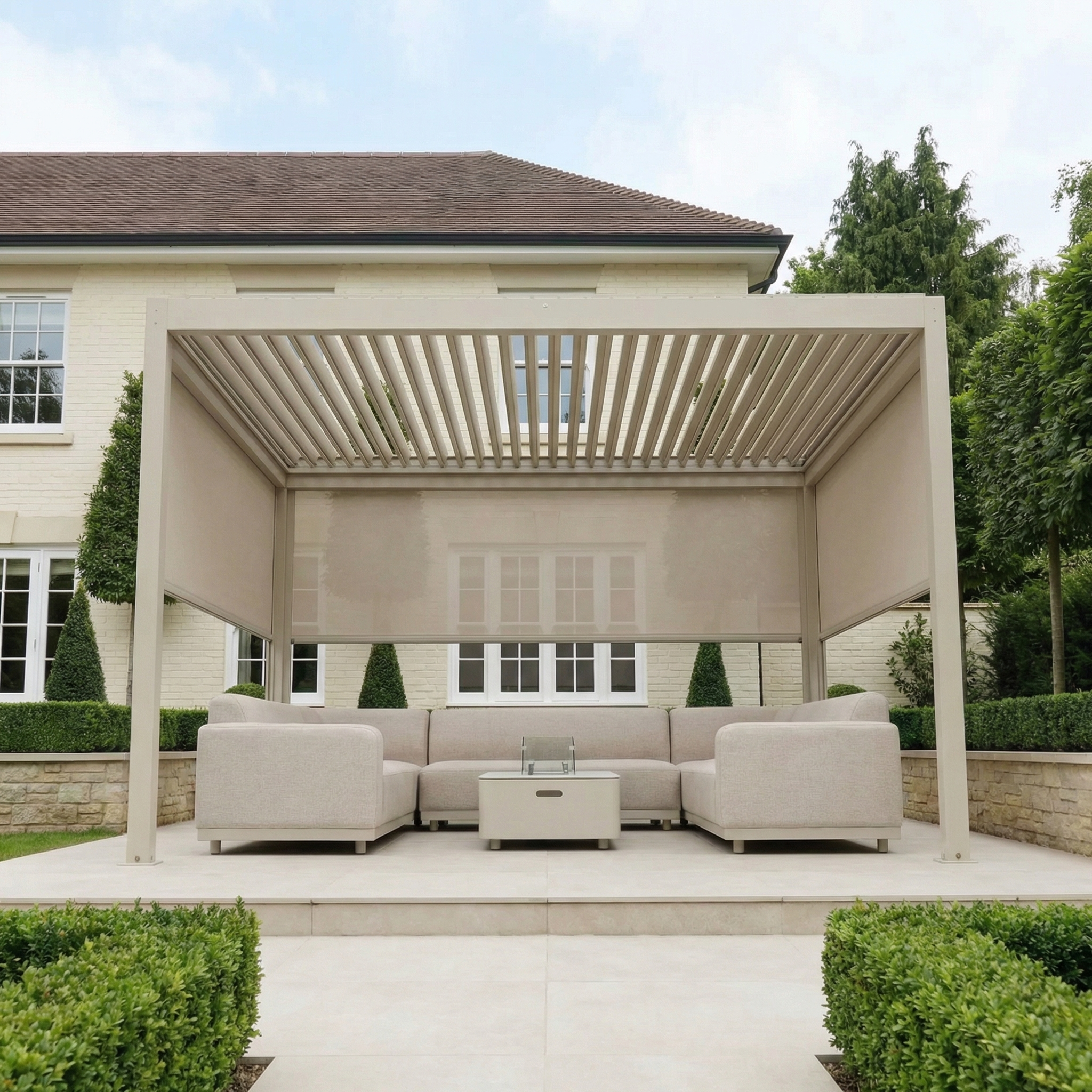 Contemporary patio with PergoSTET Plus 3m x 4m Rectangular Pergola in Latte, featuring a sofa set, coffee table, 3 manual side blinds for shade, and LED lighting—an inviting outdoor space in front of the house.