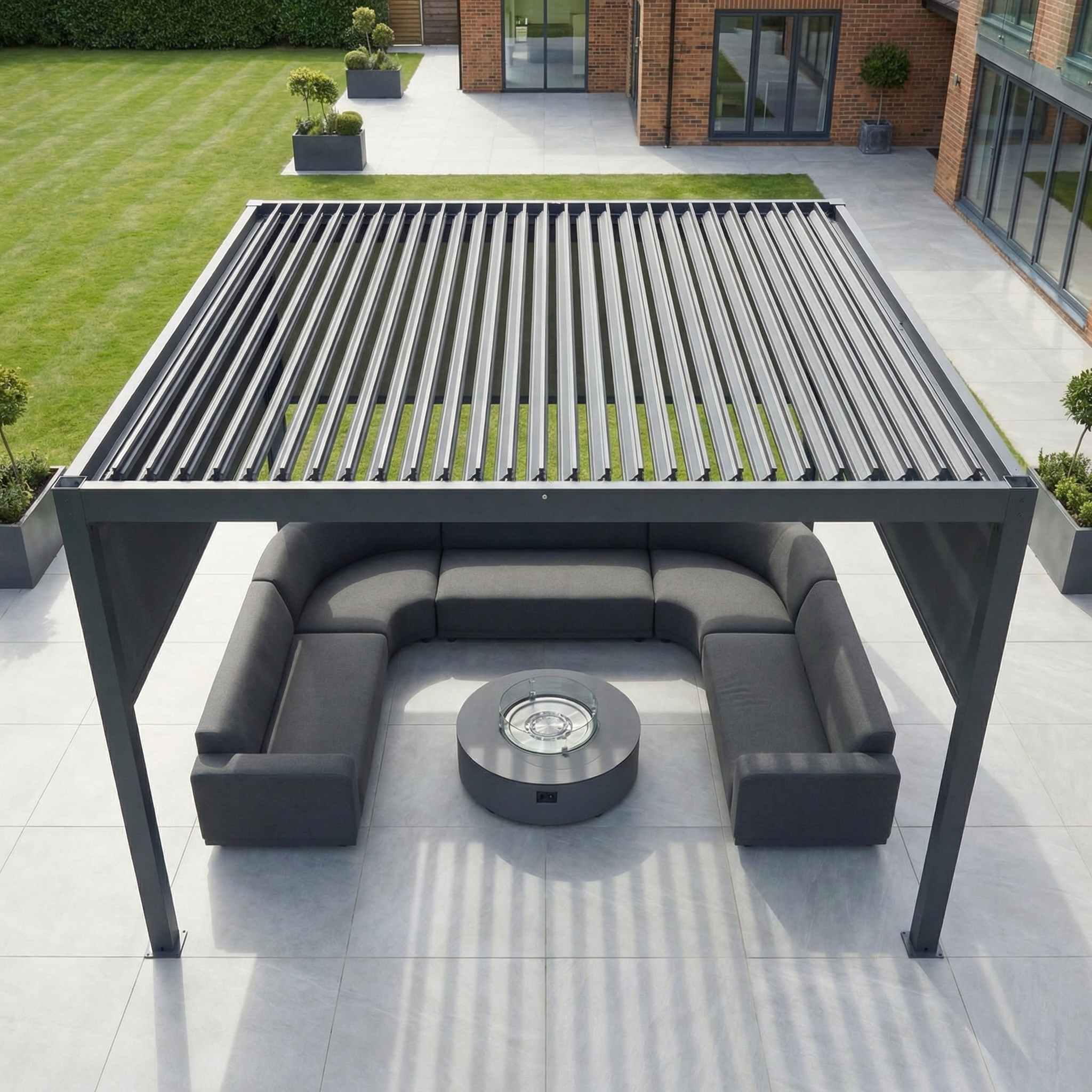 Contemporary outdoor seating area beneath the PergoSTET Plus 4m x 4m Square Pergola with 3 manual side blinds and LED lighting in grey, featuring a fire pit table on a tiled patio near the building.
