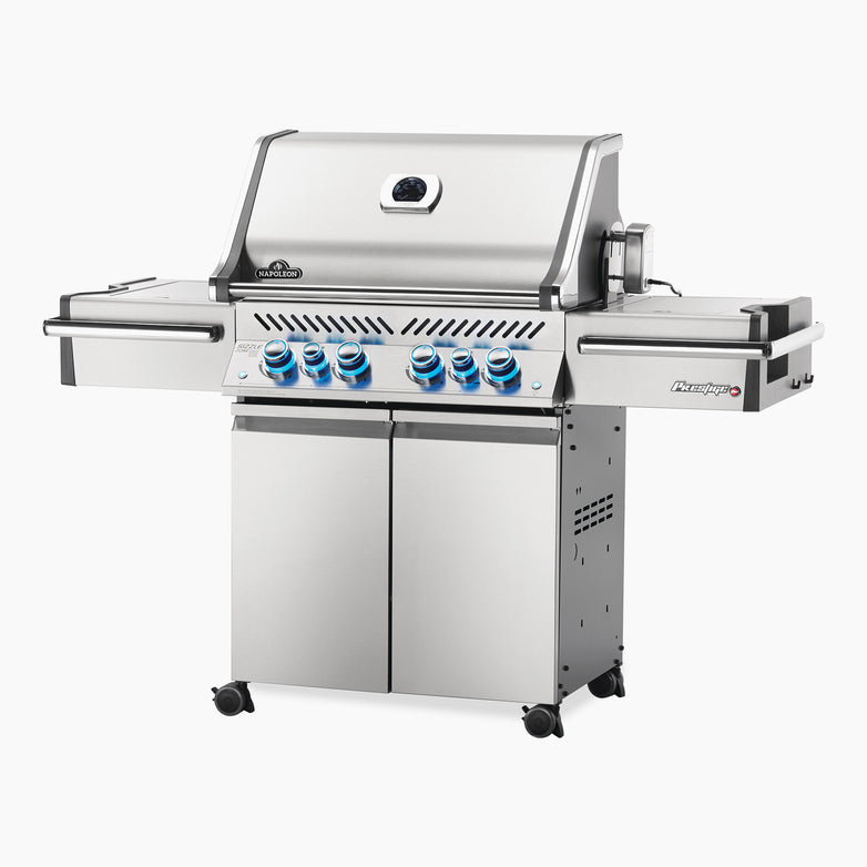 A Napoleon Prestige Pro 500 RSIB Gas Barbecue featuring stainless steel construction, blue-lit control knobs, dual side shelves, and infrared rear and side burners.