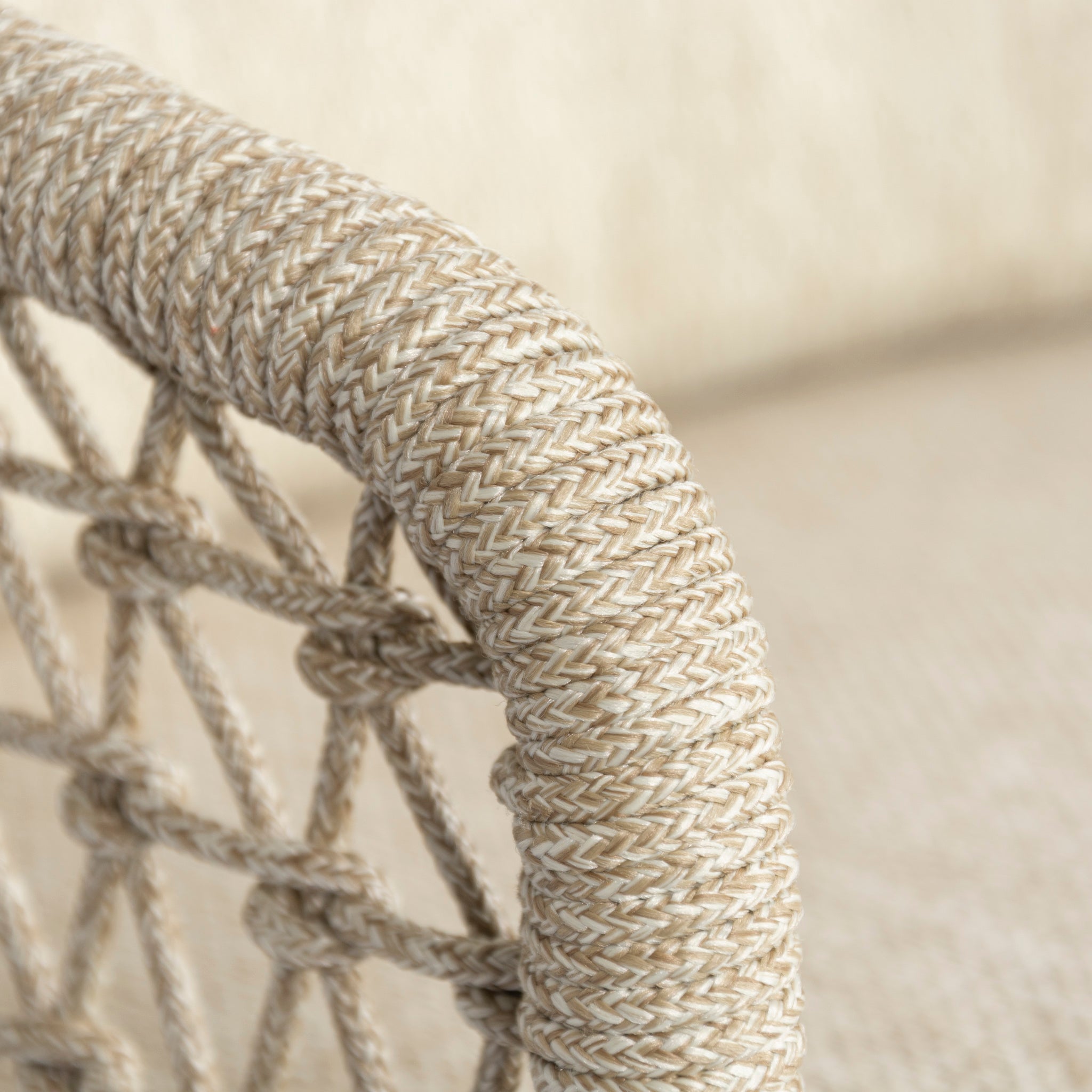 Close-up of a beige woven rope detail on the backrest of a chair from the Puccini 6 Seat Round Dining Set with Lazy Susan in Latte, against a neutral background.