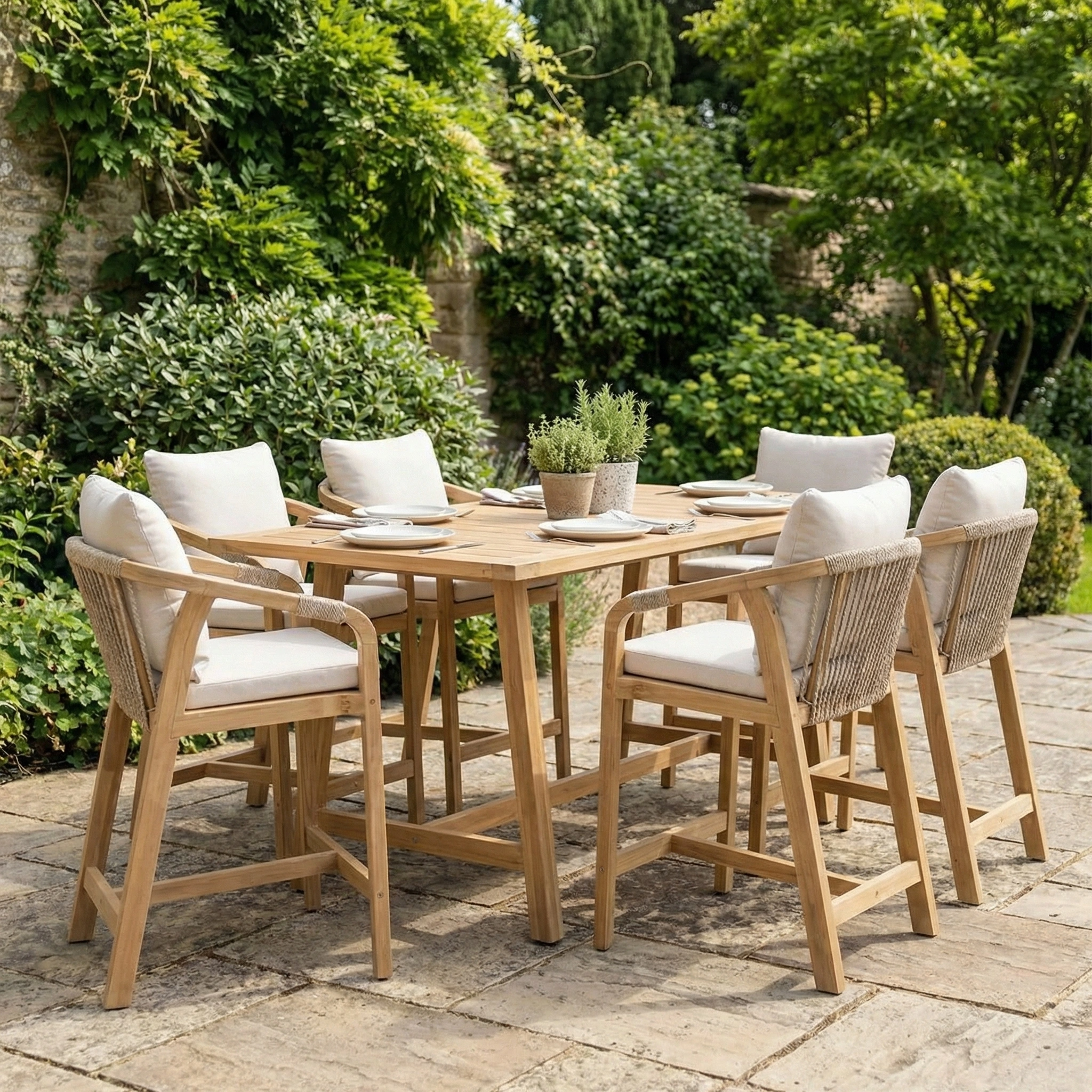 Quay 6 Seat Rectangular Bar Set in Linen features six cushioned chairs and a sleek table, creating the perfect outdoor dining space for your garden oasis amidst lush greenery.