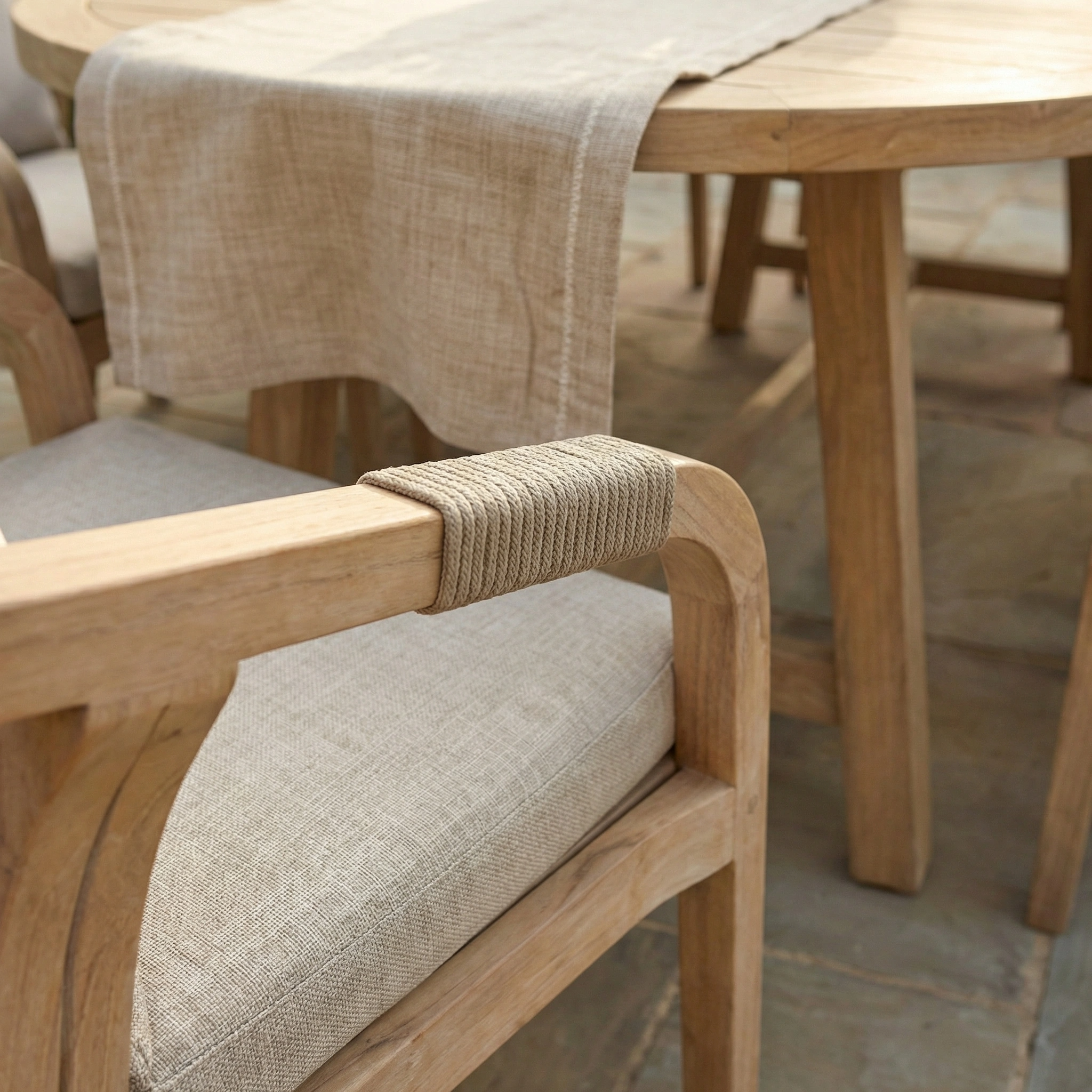 Close-up of a wooden chair arm with rope detail and beige cushion from the Quay 8 Seat Oval Dining Set in Mocha, crafted from elegant eucalyptus wood for stylish outdoor dining.