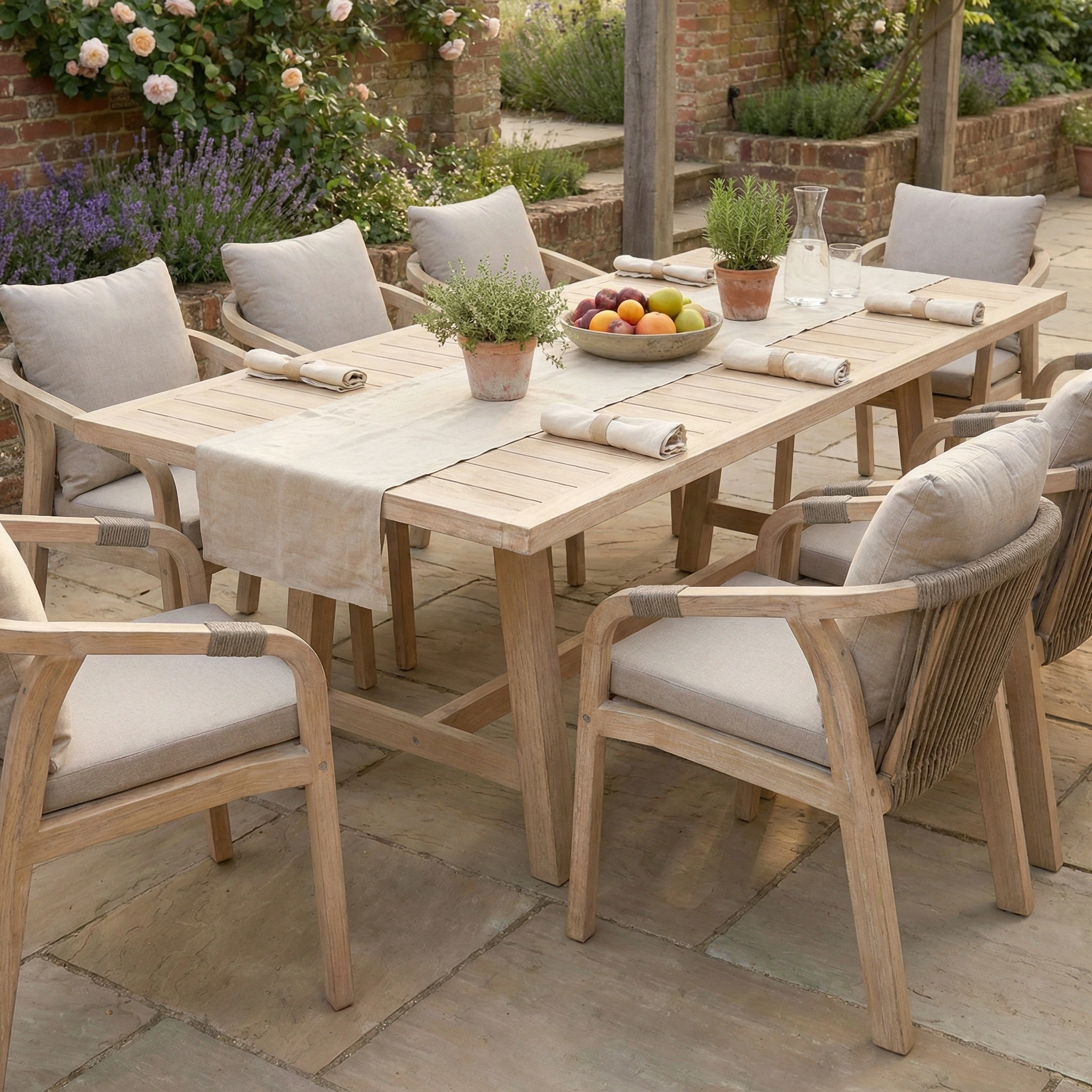 Quay 8 Seat Rectangular Dining Set in Mocha—an elegant eucalyptus outdoor ensemble with cushioned chairs, napkins, fruit bowl, water carafe, and flowers for memorable garden dining.