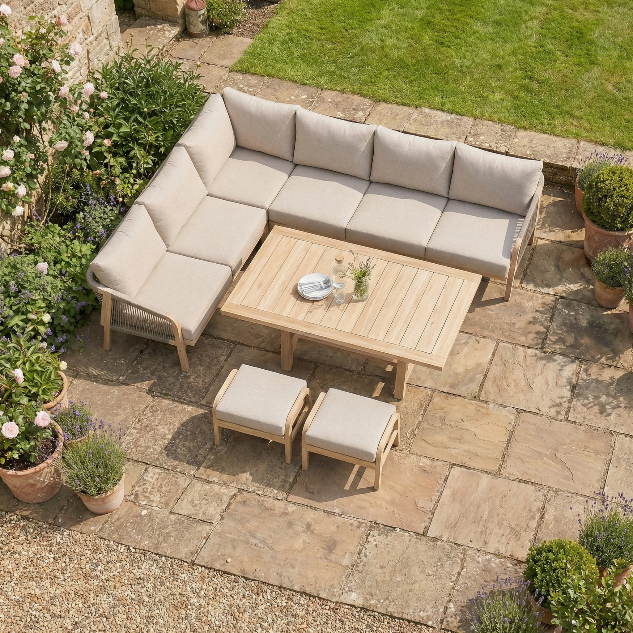 The Quay Corner Dining Set in Mocha sits on a stone patio, surrounded by potted plants and greenery—a perfect spot to relax with stylish outdoor dining furniture.