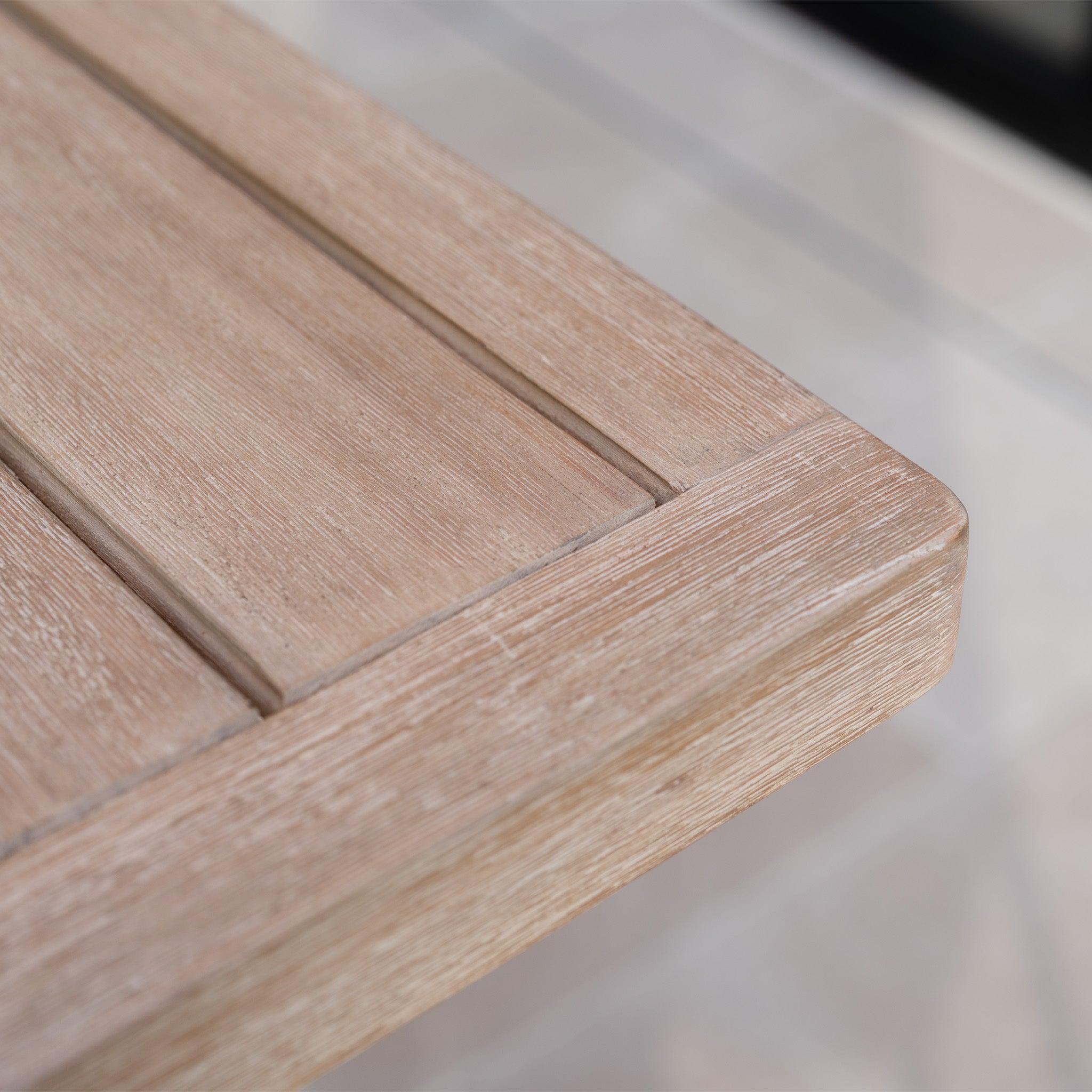 Close-up of the light wood, grooved surface and smooth finish of the Quay Corner Sofa Dining Set in Mocha, ideal for outdoor dining.