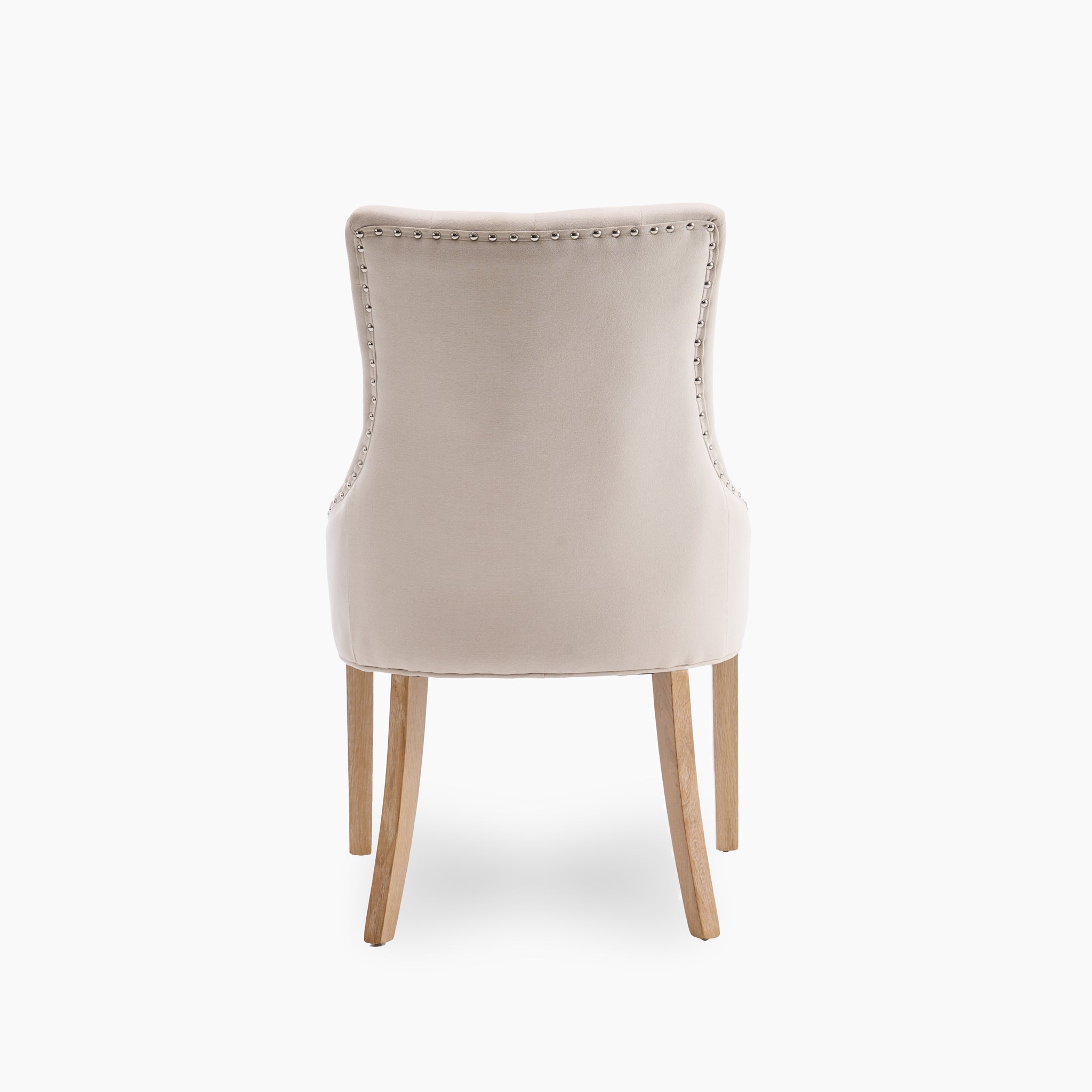 Beige upholstered chair with nailhead trim and wooden legs, shown from the back, pairs beautifully with the Burford 8 Seat Extending Dining Set with Regent Chairs in Natural Oak and Ivory.