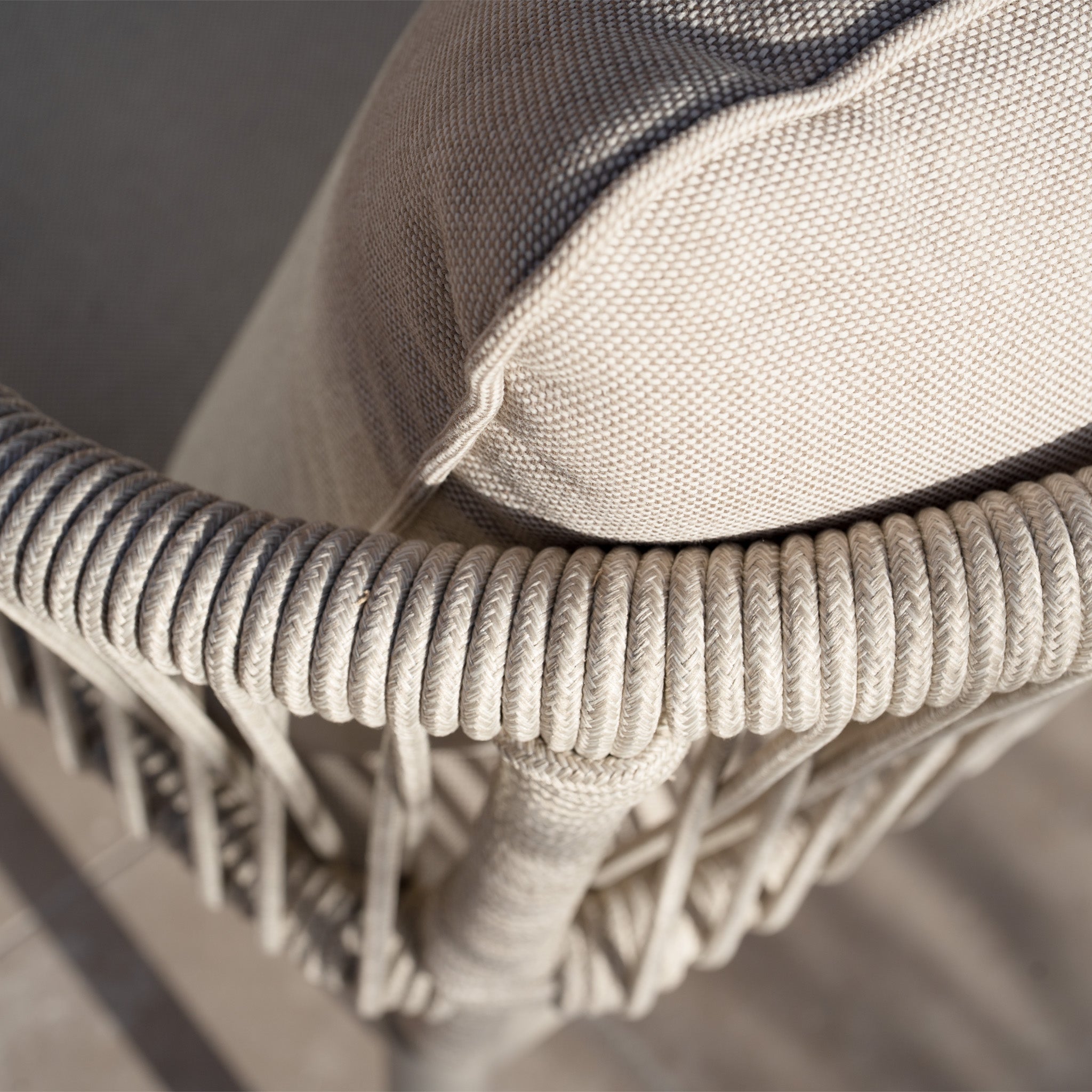 Close-up of the Rhea 2 Seat Sofa Set in Latte, featuring a beige woven frame with detailed rope wrapping and a textured fabric cushion, highlighting the refined craftsmanship of premium aluminium garden furniture.