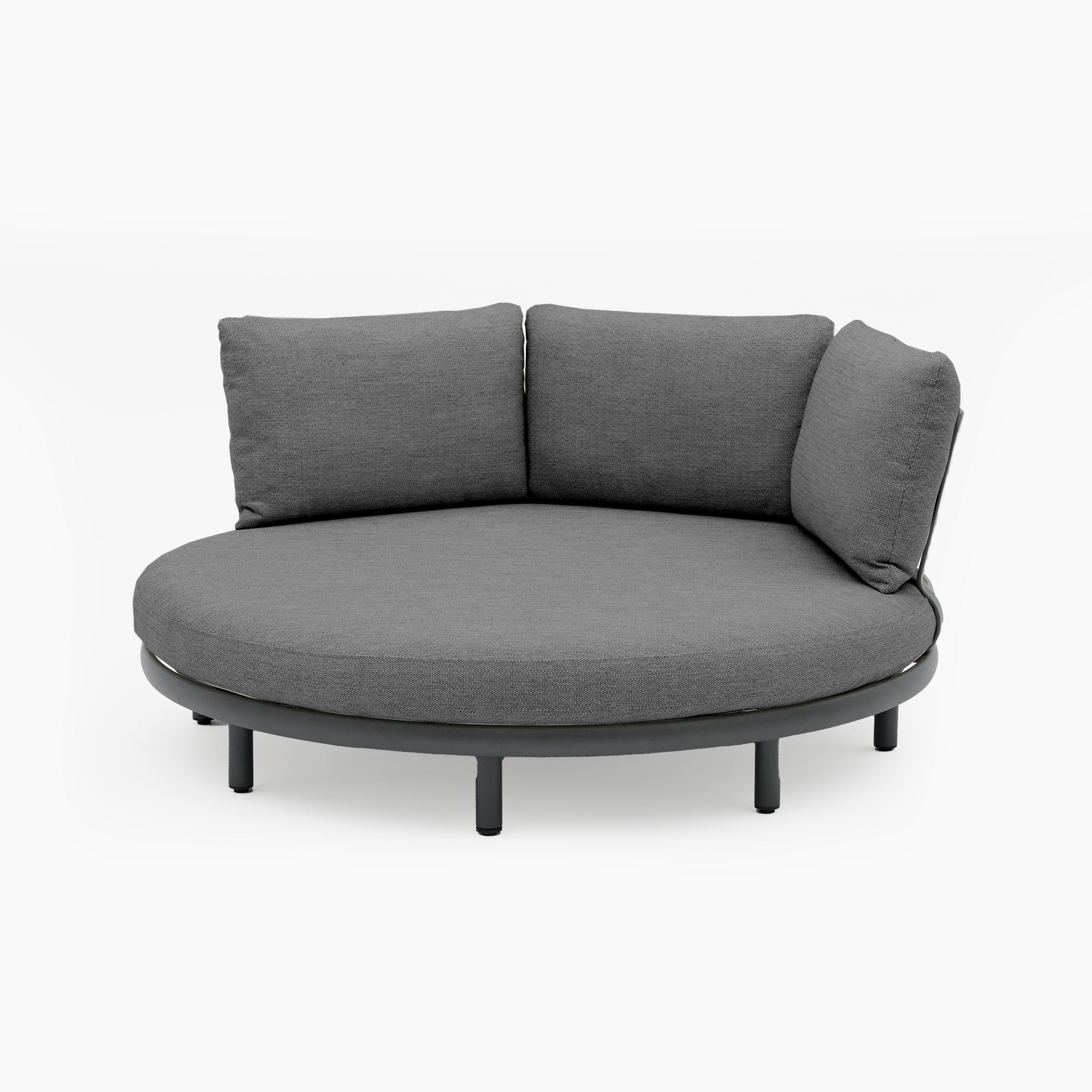 The Selene Daybed in Charcoal is a round sofa with a low, modern design and three back cushions set against white. Its weather-resistant materials make it perfect for stylish and durable outdoor luxury.