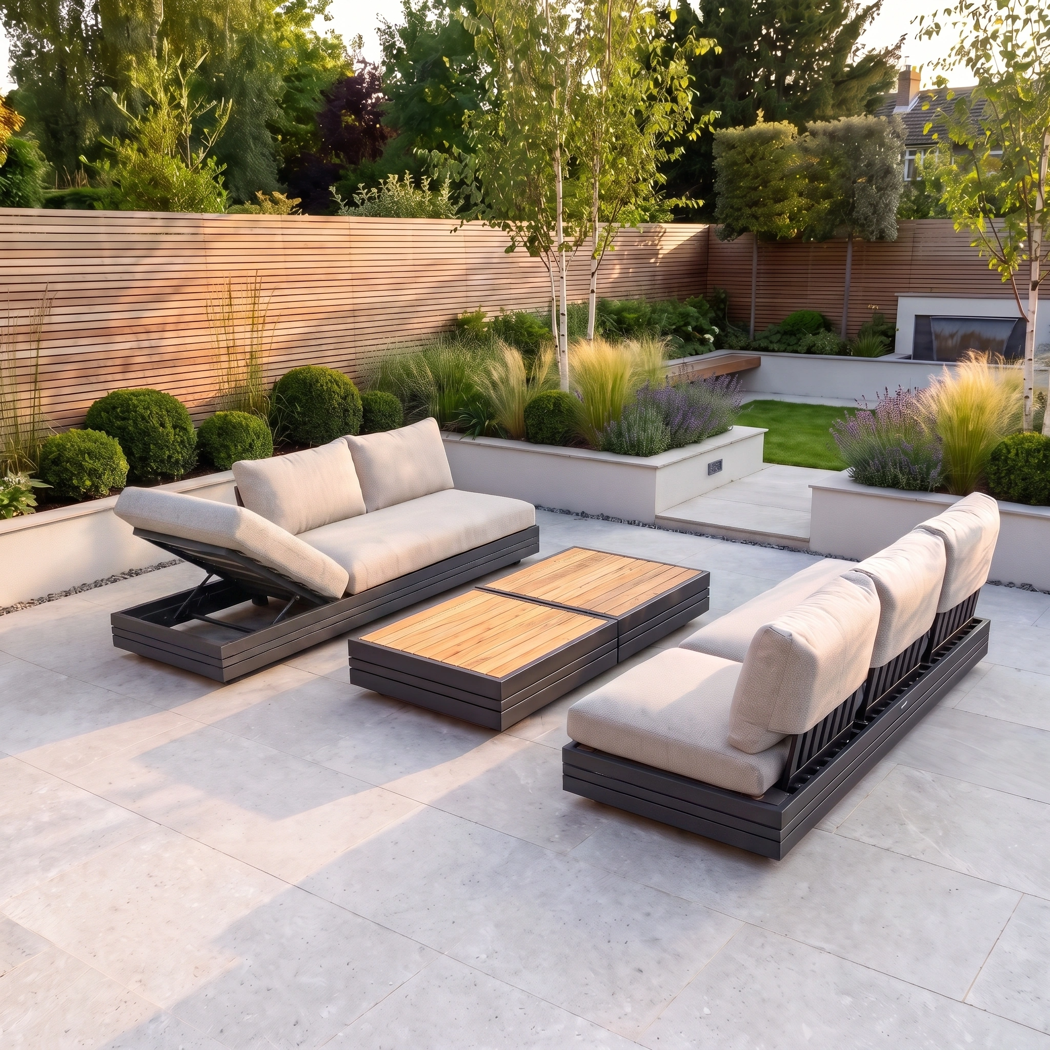 Modern outdoor patio with cushioned seating and a beautifully landscaped garden in the background, featuring the Savona 6 Seat Sofa Set with Panama Coffee and Side Tables in Truffle. The space is enhanced by this aluminium outdoor sofa set, offering UV resistant garden furniture for lasting style and comfort.