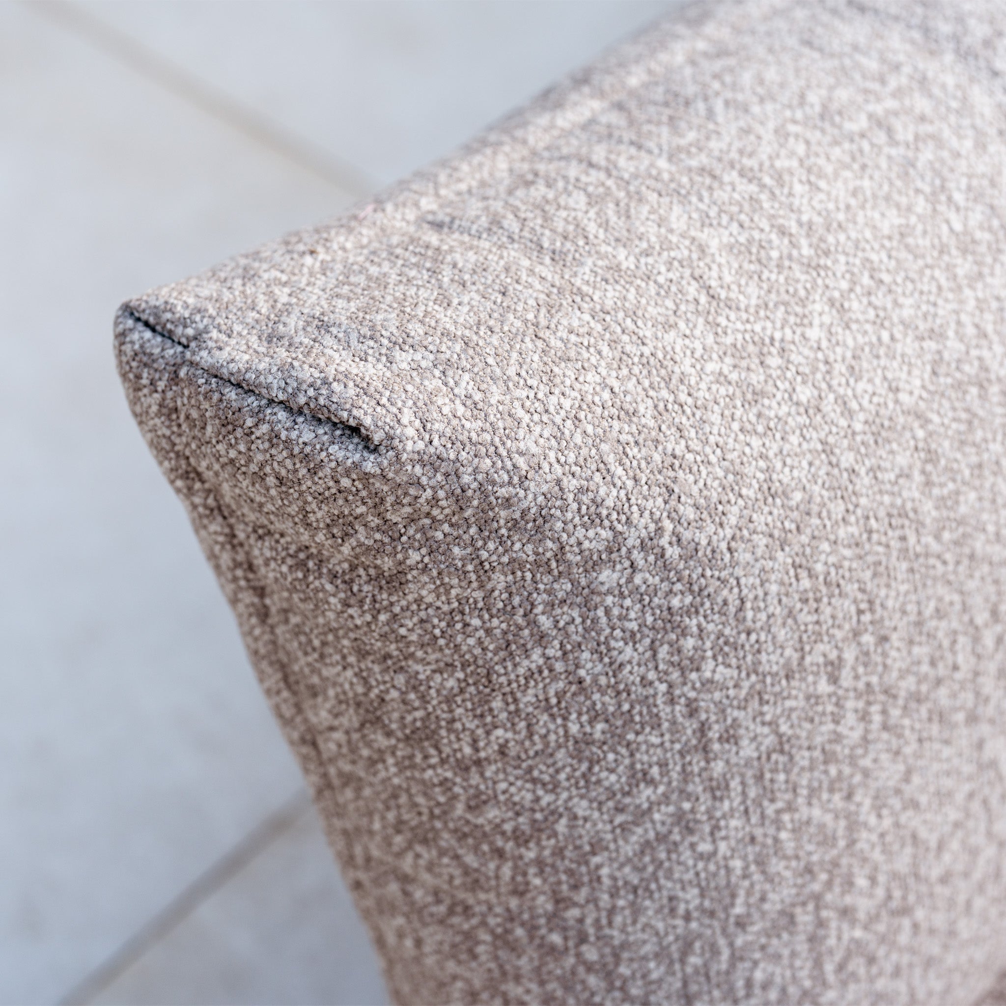 Close-up of a textured, light brown cushion with corner stitching, ideal for complementing the Savona Luxury Outdoor Large Corner Sofa Set with Altura Rising Table in Truffle.