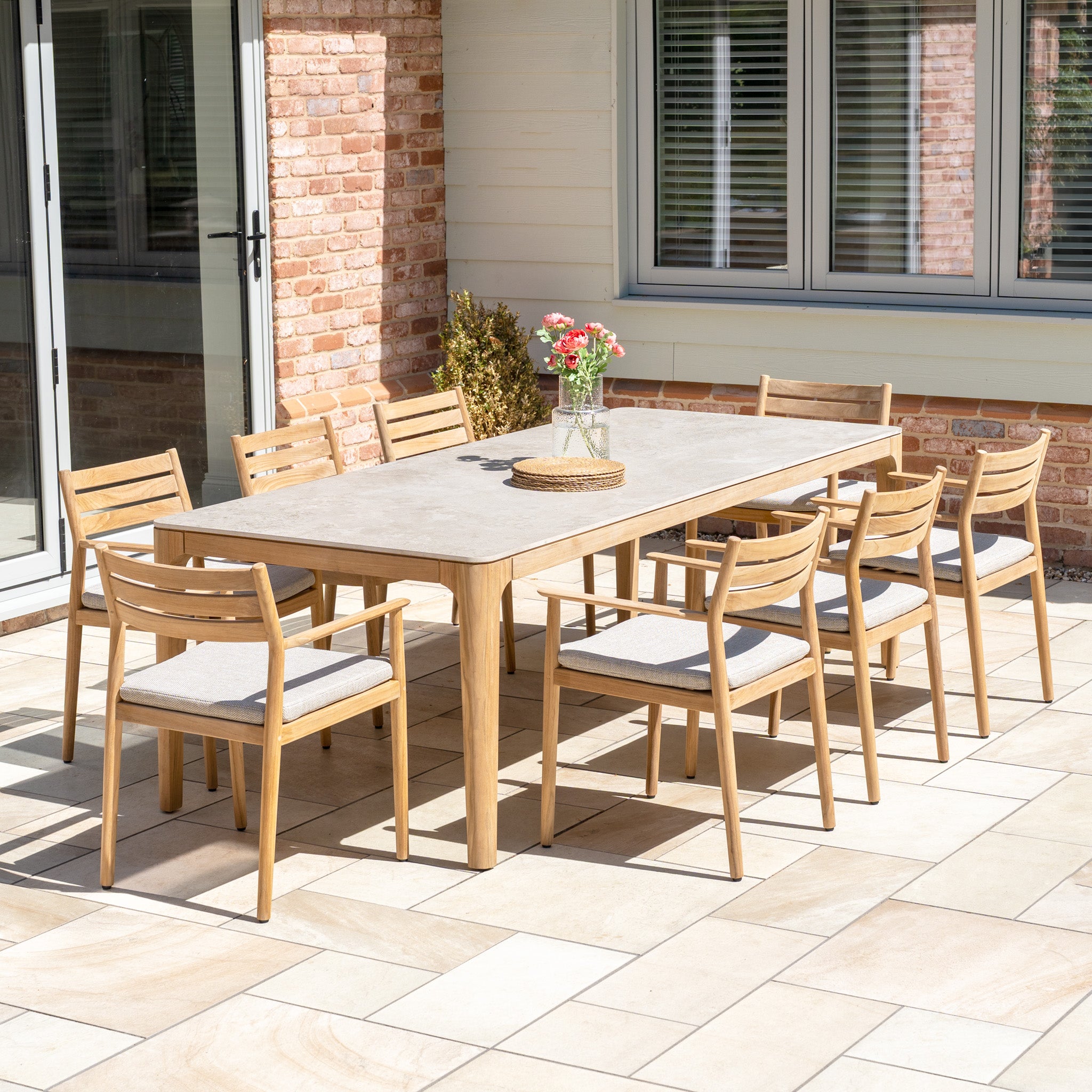 The Siena 8 Seat Dining Set with Ceramic Top Table in Fawn includes spacious seating and a stylish ceramic table, perfect for outdoor gatherings and adding charm to your patio.