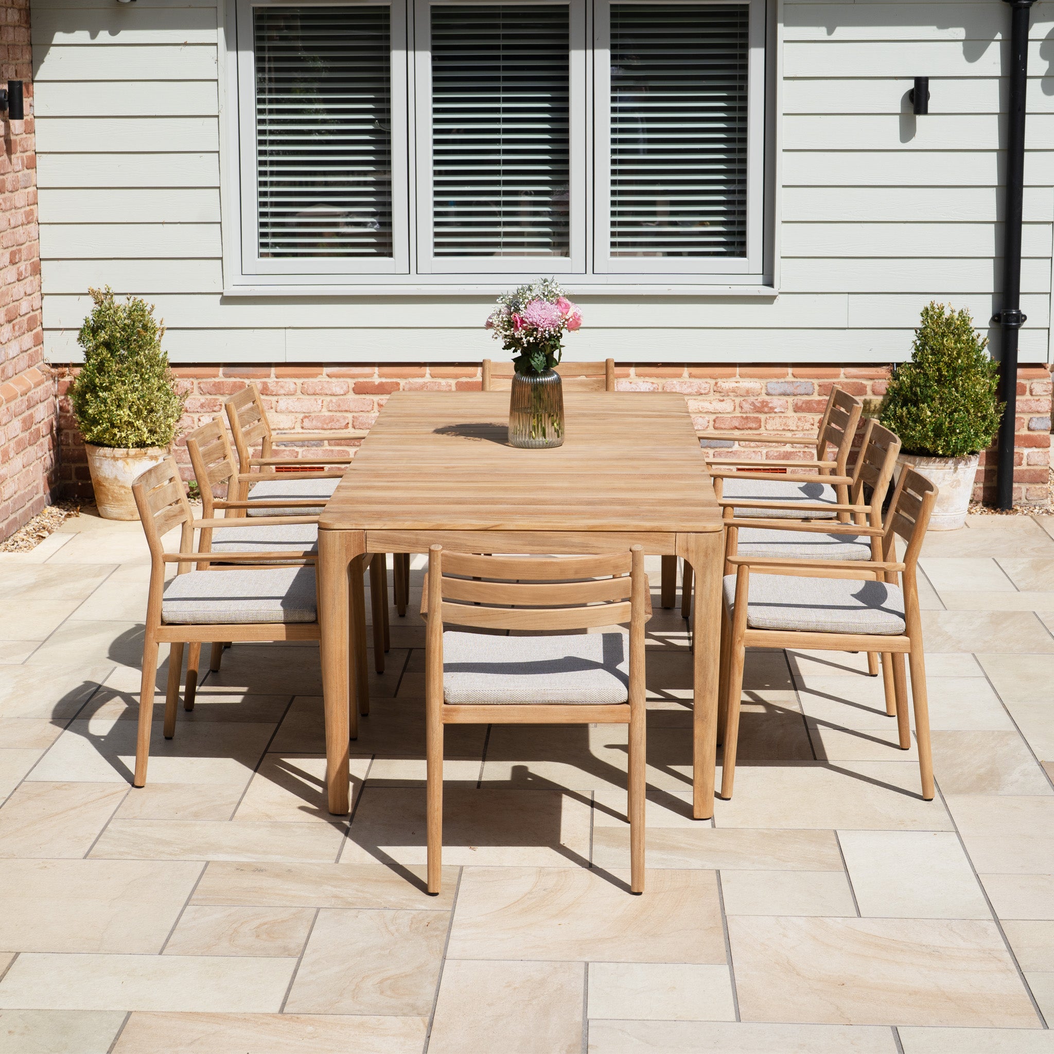 The Siena 8 Seat Dining Set with Teak Table in Fawn includes a teak table and eight chairs—perfect for outdoor patio dining near your home.