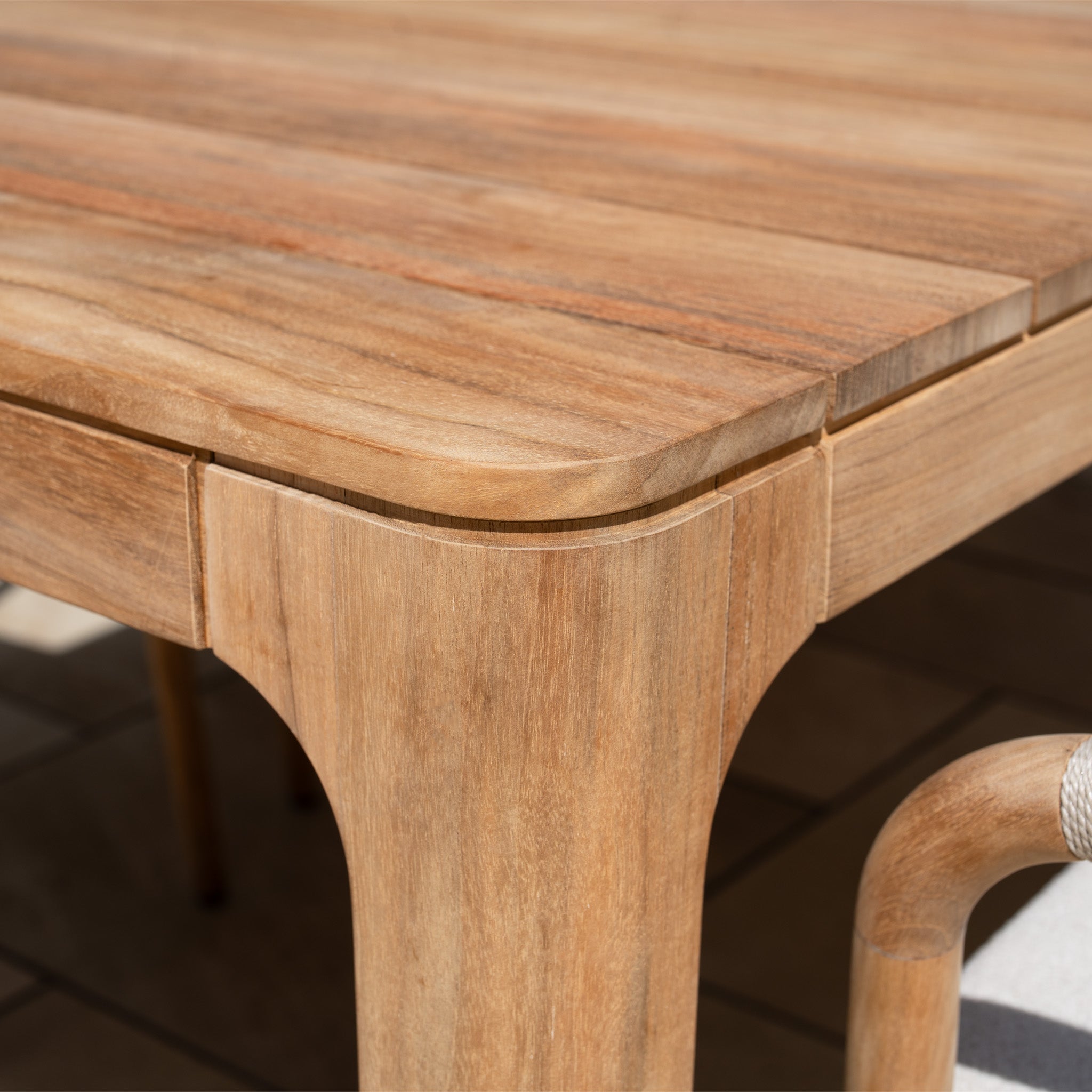 Close-up of the Sora 8 Seat Rope Dining Set with Teak Table in Stone, showing smooth corners, a natural finish, and refined outdoor craftsmanship.