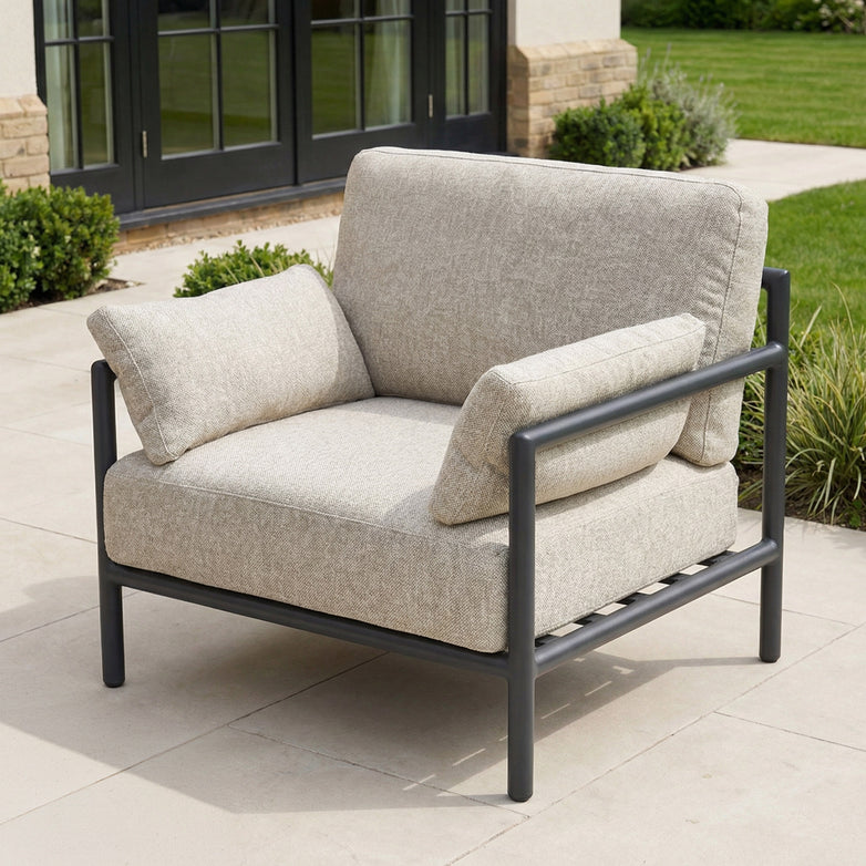 Modern outdoor armchair with light beige cushions and black metal frame, designed to complement the Sorelli 2 Seat Sofa Set in Truffle for a cohesive patio look.