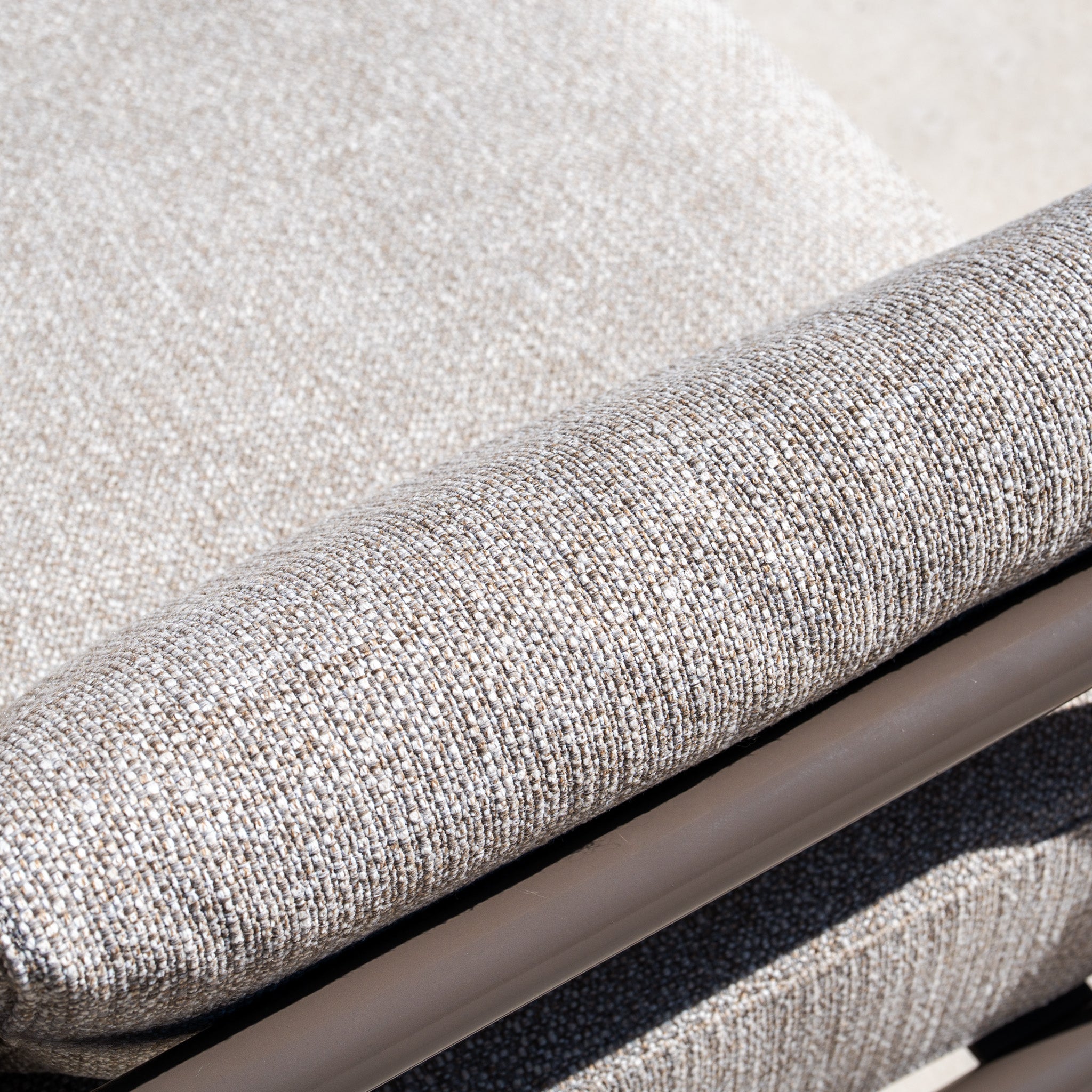 Close-up of a cushioned armrest with textured oatmeal fabric and an aluminium frame, perfect for complementing your Sorelli Corner Sofa Set in Oatmeal.