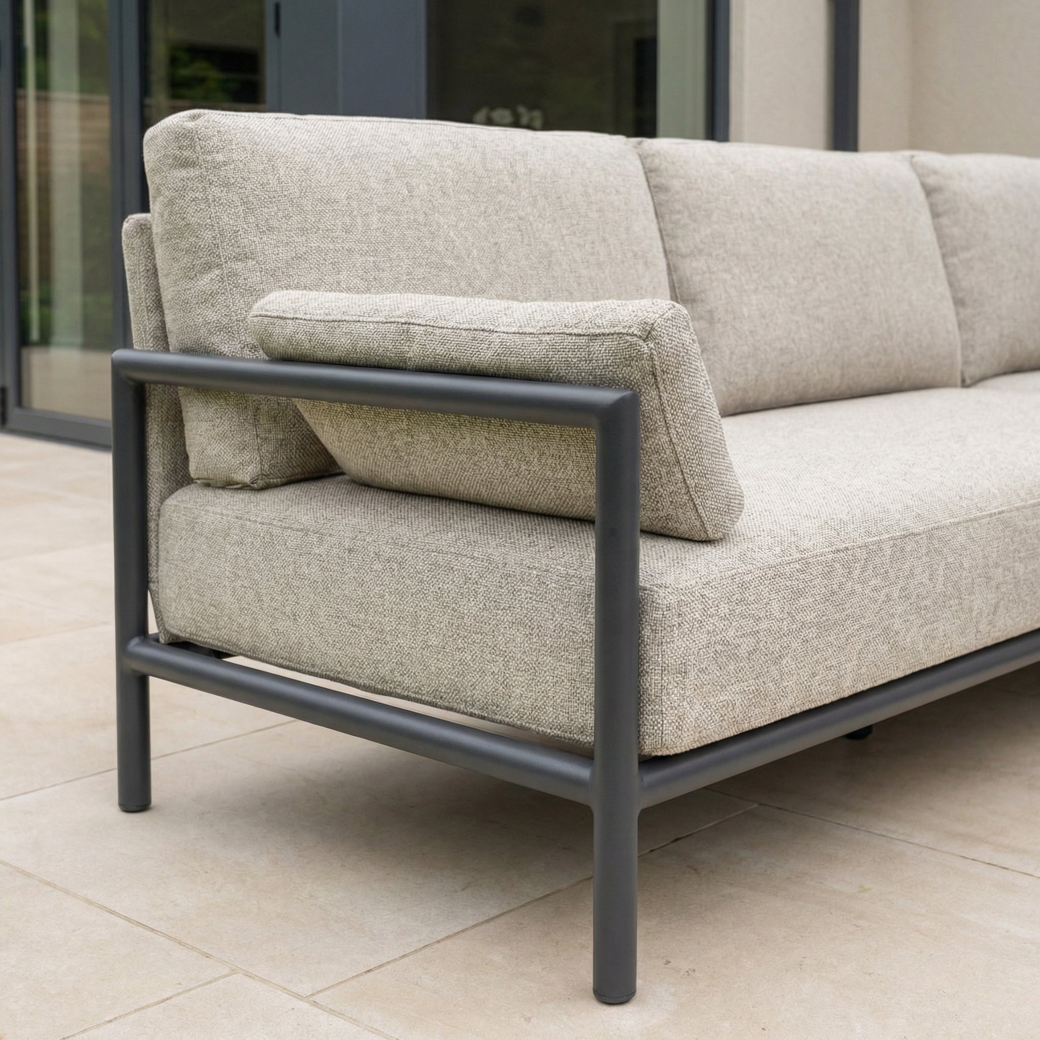 The Sorelli U Shape Corner Sofa Set in Truffle features weather-resistant cushions and a sturdy metal frame, making it ideal for outdoor entertaining on your patio near glass doors.