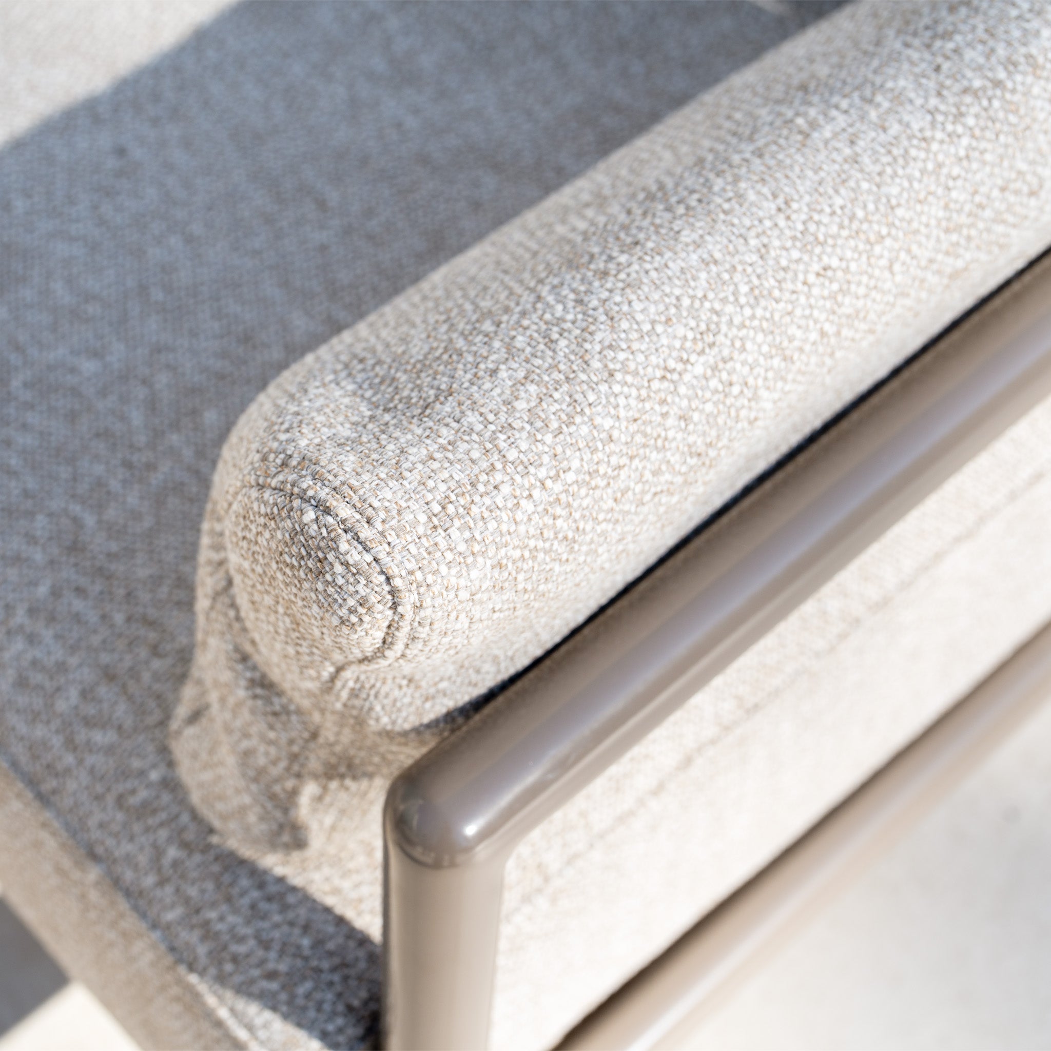 Close-up of the Sorelli U Shape Corner Sofa Set in Oatmeal, featuring a light beige upholstered armrest with an aluminium frame, captured in natural light.