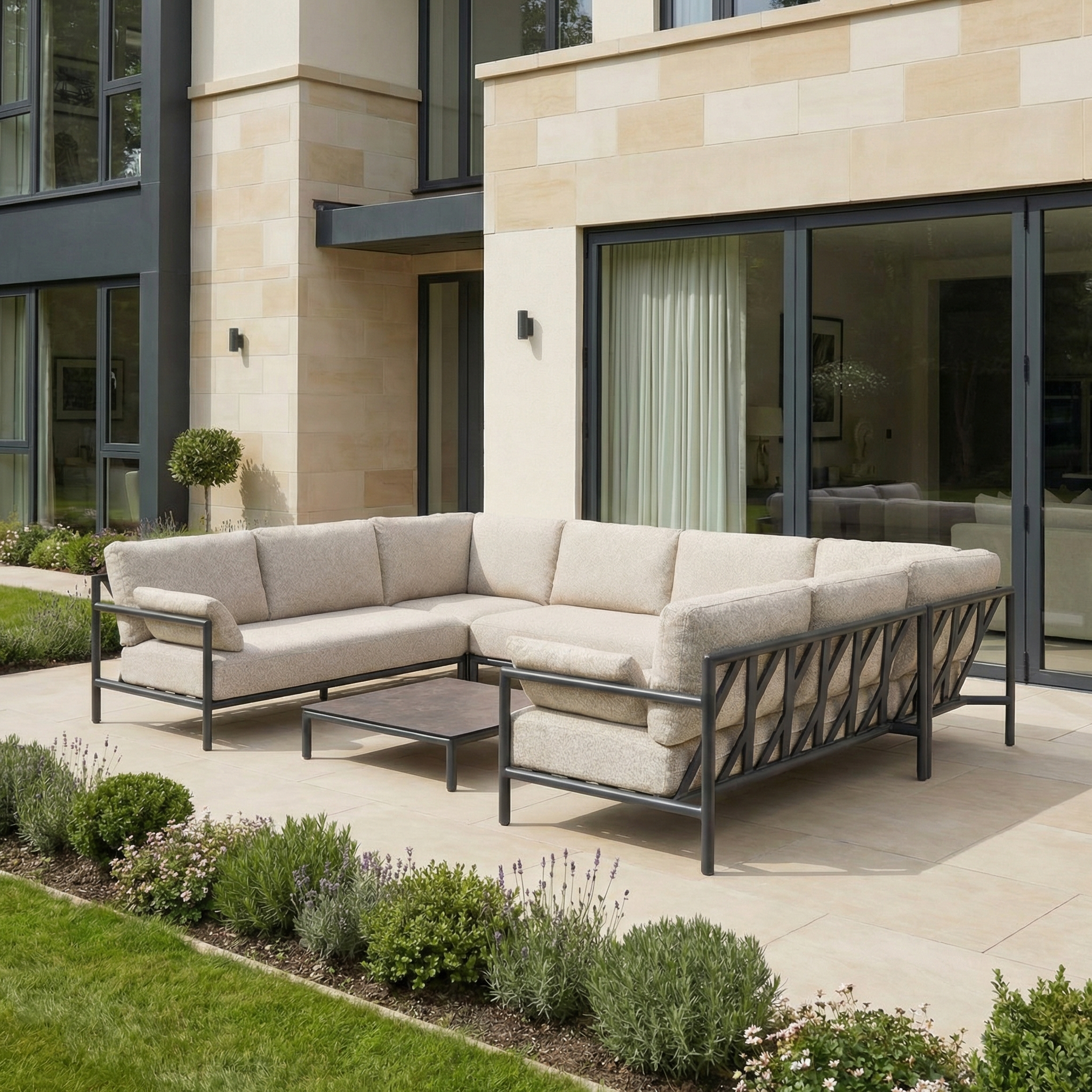 The Sorelli U Shape Corner Sofa Set in Truffle with a coffee table is perfect for outdoor entertaining and relaxing among greenery and modern architecture.
