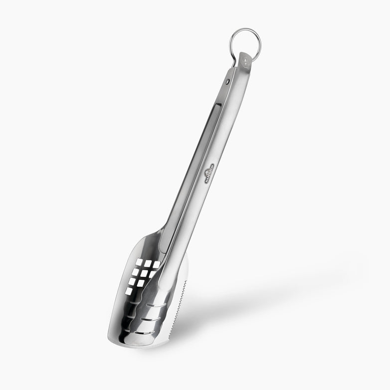 The Napoleon Stainless Steel Spatutong, featuring a serrated edge, perforated square holes, and a hanging ring, is a versatile grill multi-tool perfect for any barbecue.
