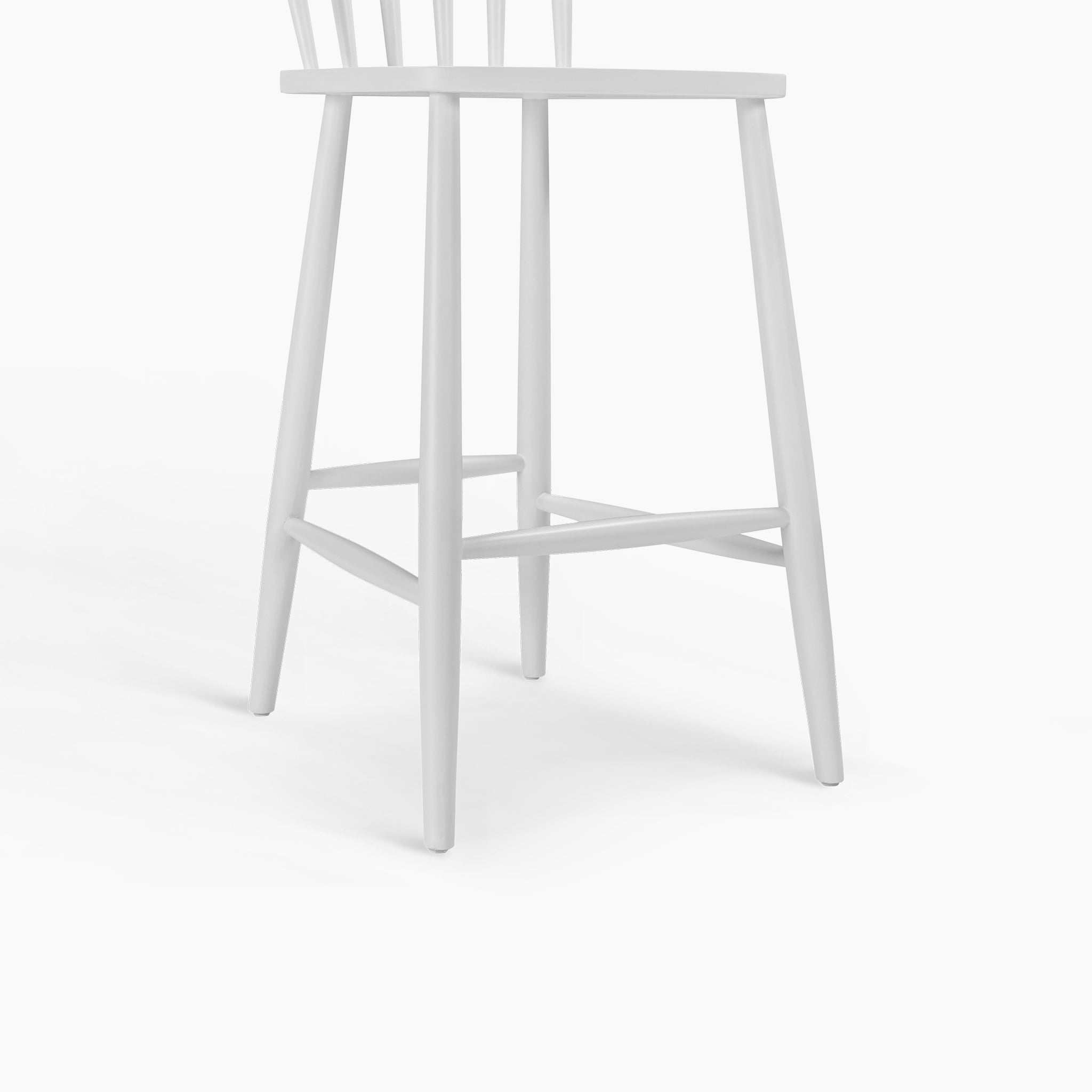 The Burford Spindleback Bar Stool in Warm White features four angled legs and a flat seat, ideal for kitchen island seating, shown against a plain white background.