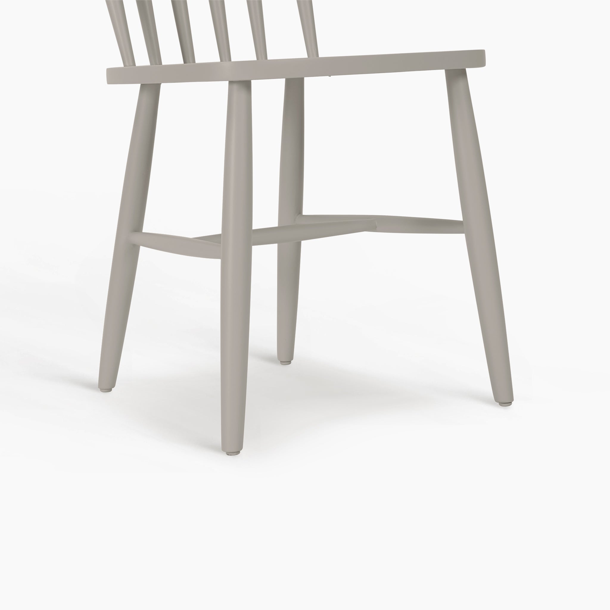 Burford Set of 2 Spindleback Dining Chairs in Pebble Grey, featuring classic spindle backrests, shown partially side-on against a white background.