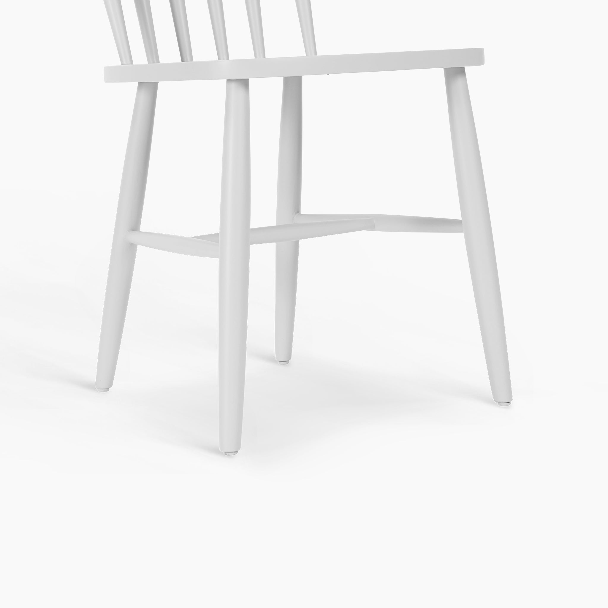 The Burford Set of 2 Spindleback Dining Chairs in Warm White features classic vertical slats and sturdy four-leg design—ideal for bringing a touch of country style to your dining area. Shown side-on against a white background.