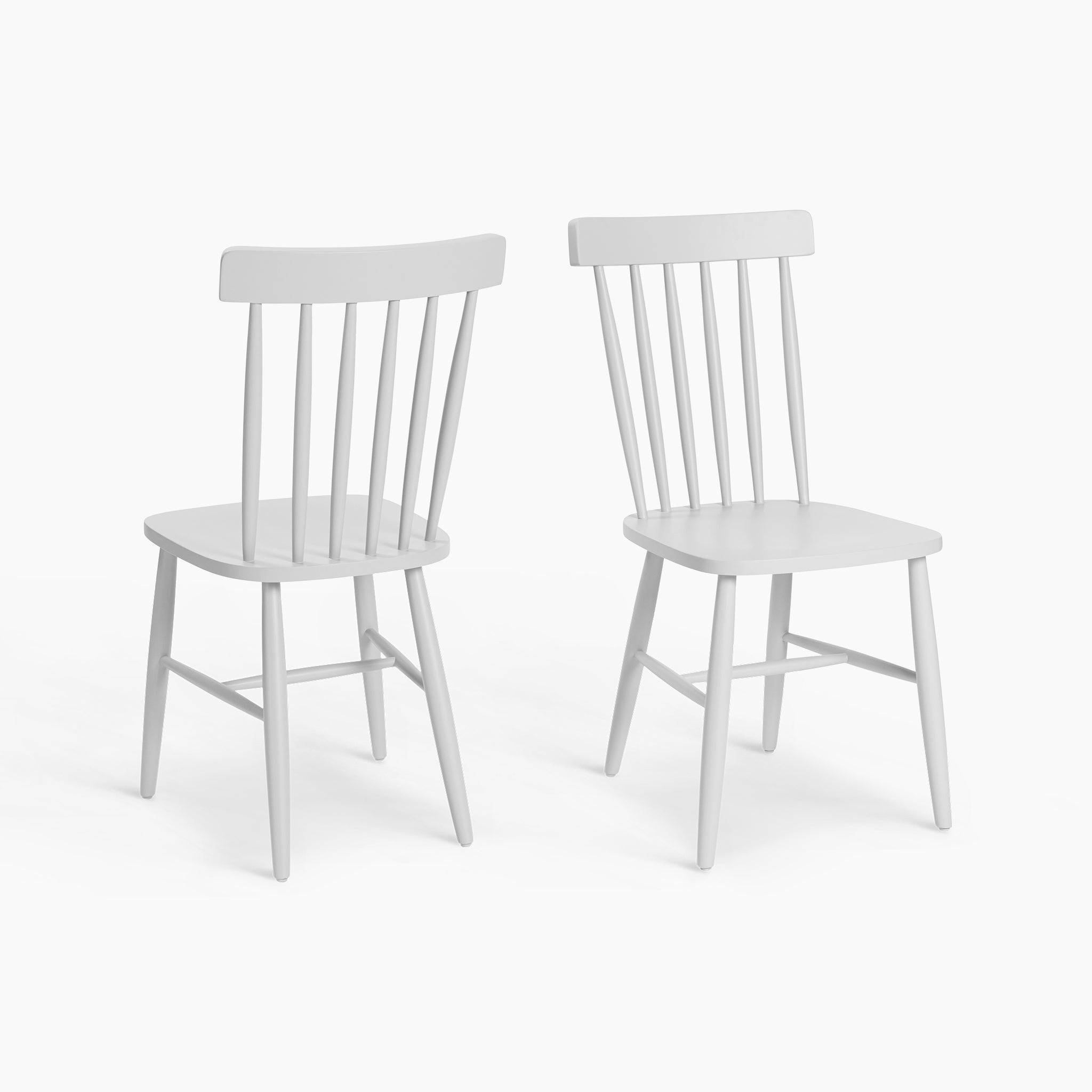 The Burford Set of 2 Spindleback Dining Chairs in Warm White, featuring classic spindle backs and angled legs, are displayed against a white background.