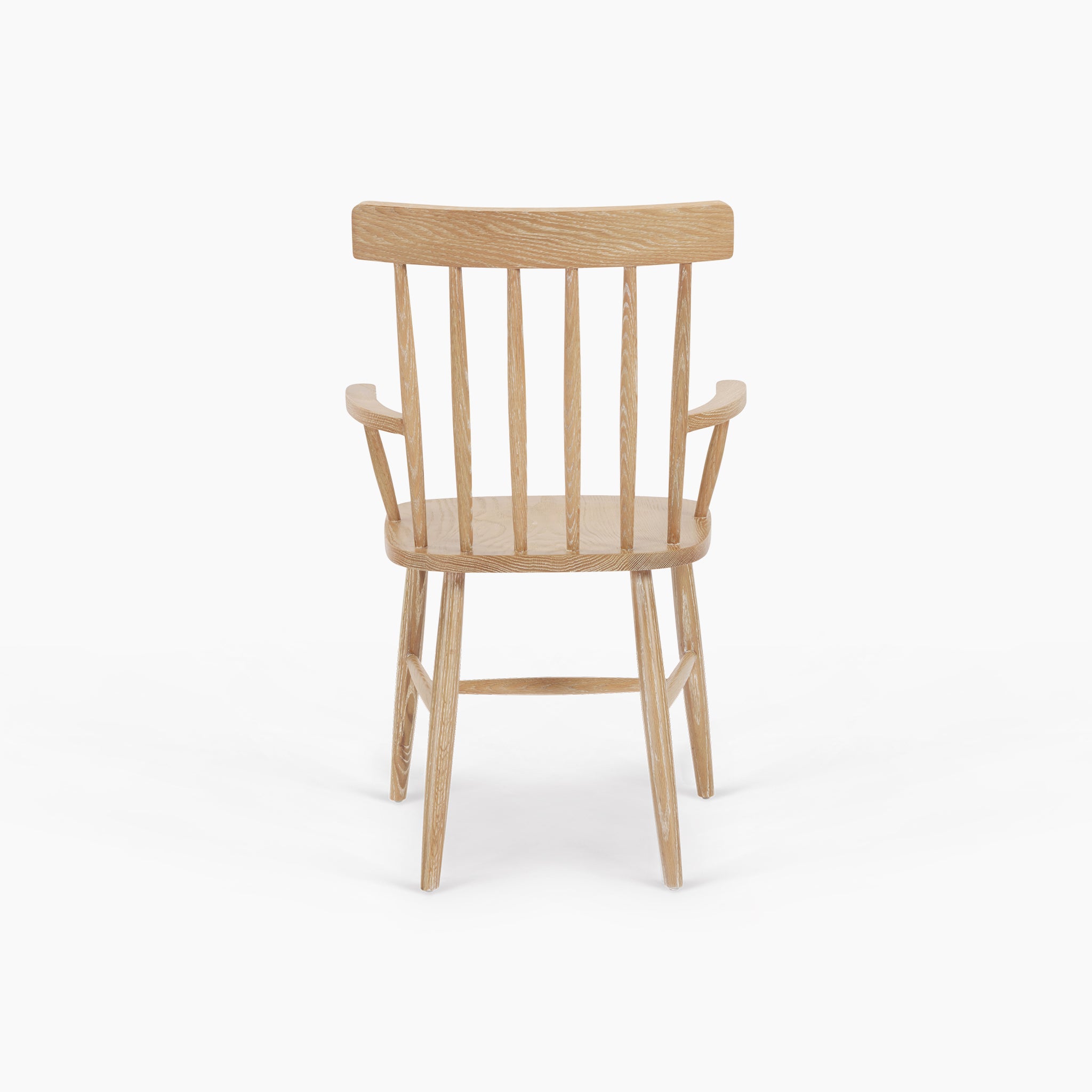Burford Spindleback Dining Chair with Armrest in Natural Oak, shown from the back against a white background.