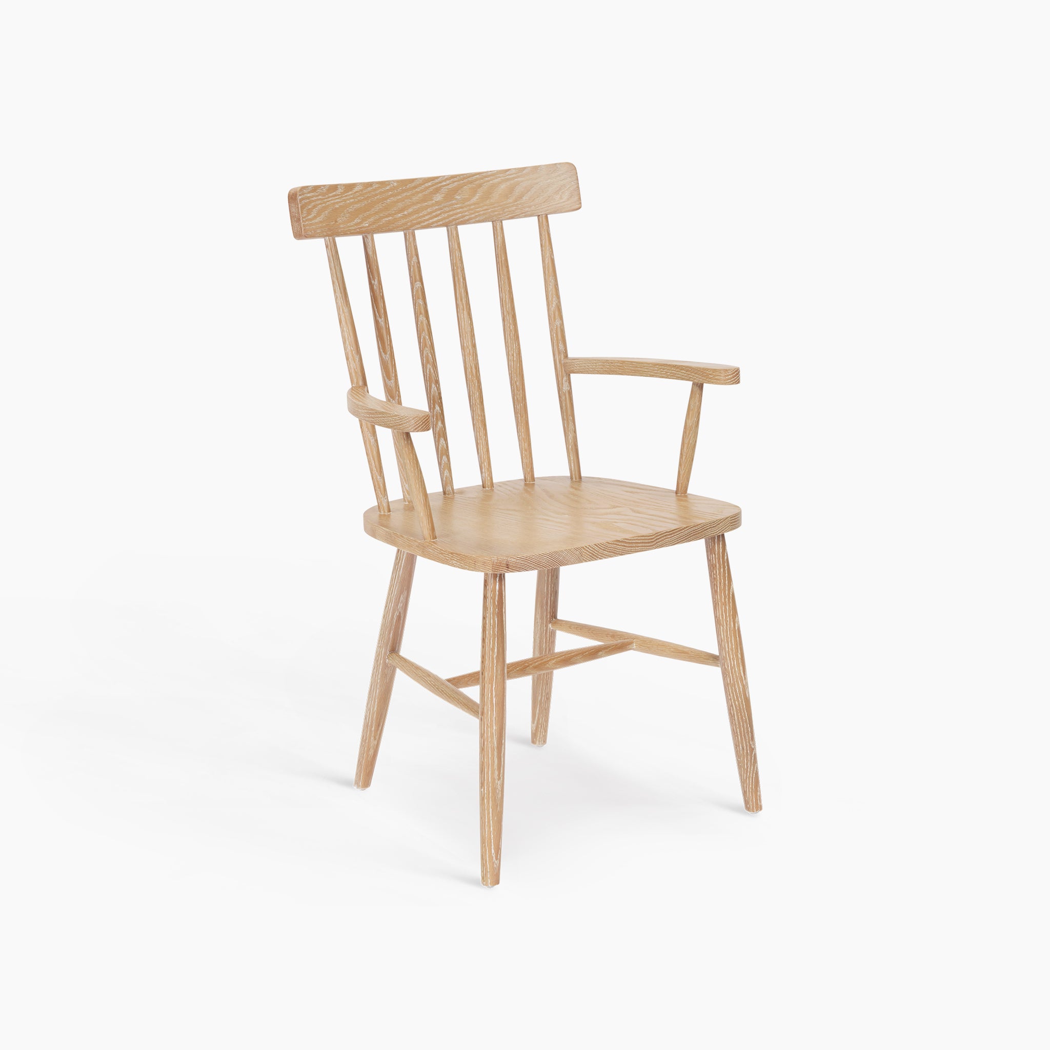 Burford Spindleback Dining Chair with Armrest in Natural Oak featuring a slatted backrest, armrests, and angled legs on a white background.