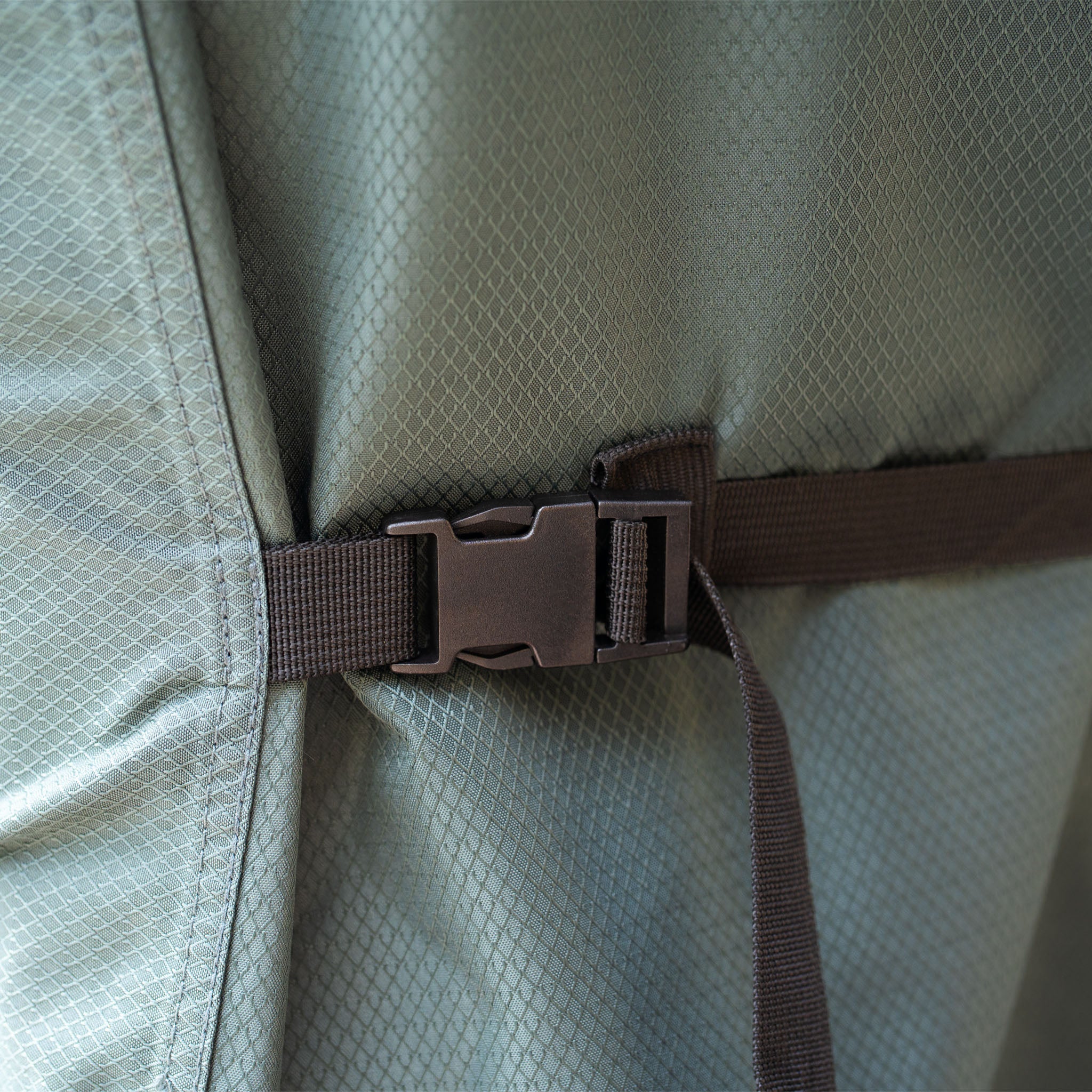 A close-up of the durable strap on the Stormtex 4 Seat Round Dining Set Cover (200x85cm), perfect for securing your outdoor furniture cover against unpredictable British weather.