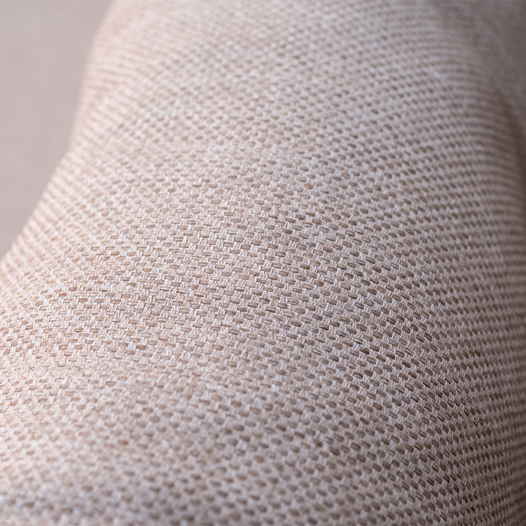 Close-up of beige woven fabric on the Sutera 3 Seat Sofa Set in Putty, featuring a slightly curved surface—perfect for all-weather cushions on your outdoor furniture.