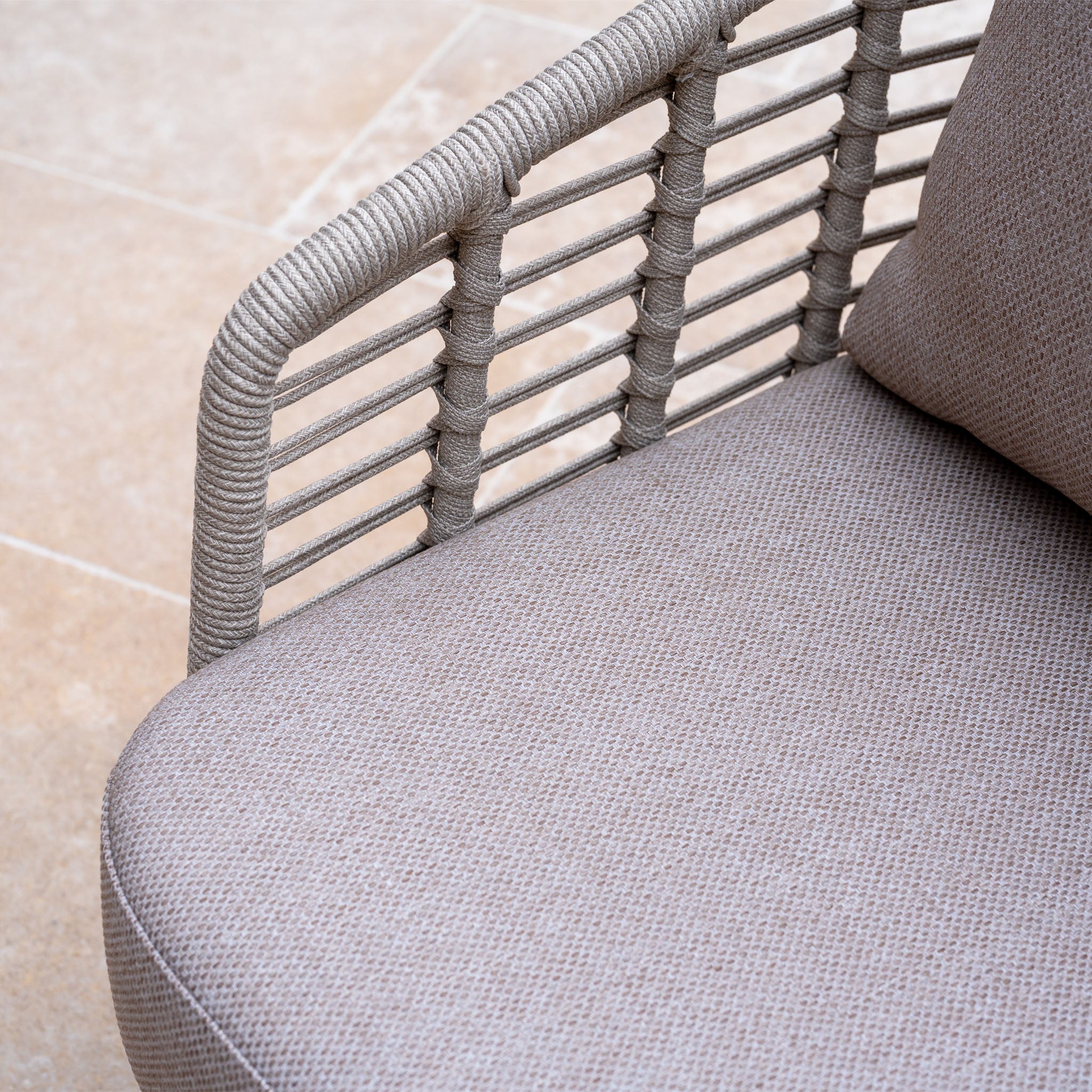 Close-up of the Sutera 3 Seat Sofa Set in Putty, featuring woven rope armrests and textured beige all-weather cushions on a tiled floor—perfect for enhancing your outdoor living space.