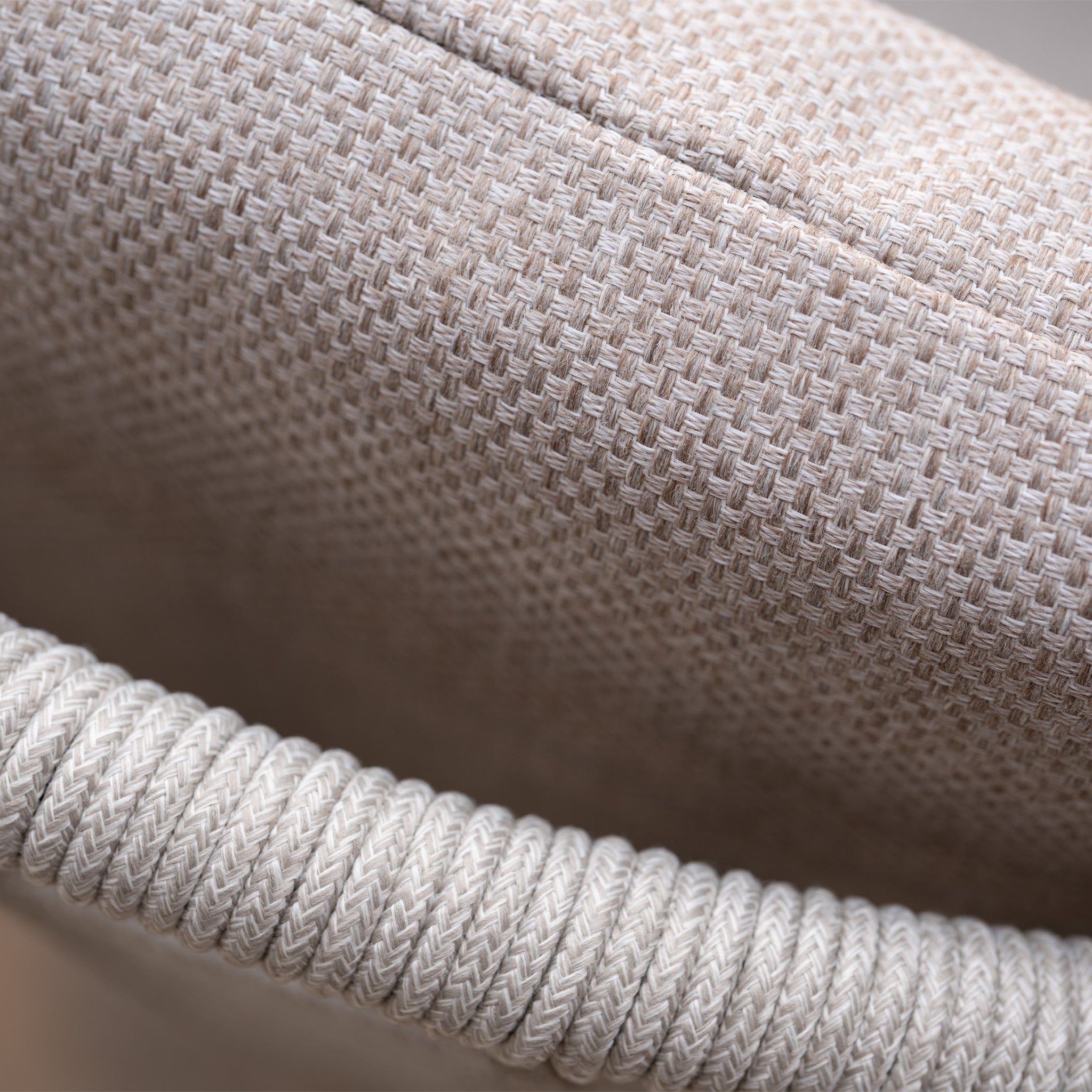 Close-up of beige woven fabric with a coiled rope edge, inspired by the refined textures of the Sutera 8 Seat Curved Rectangular Dining Set in Putty.