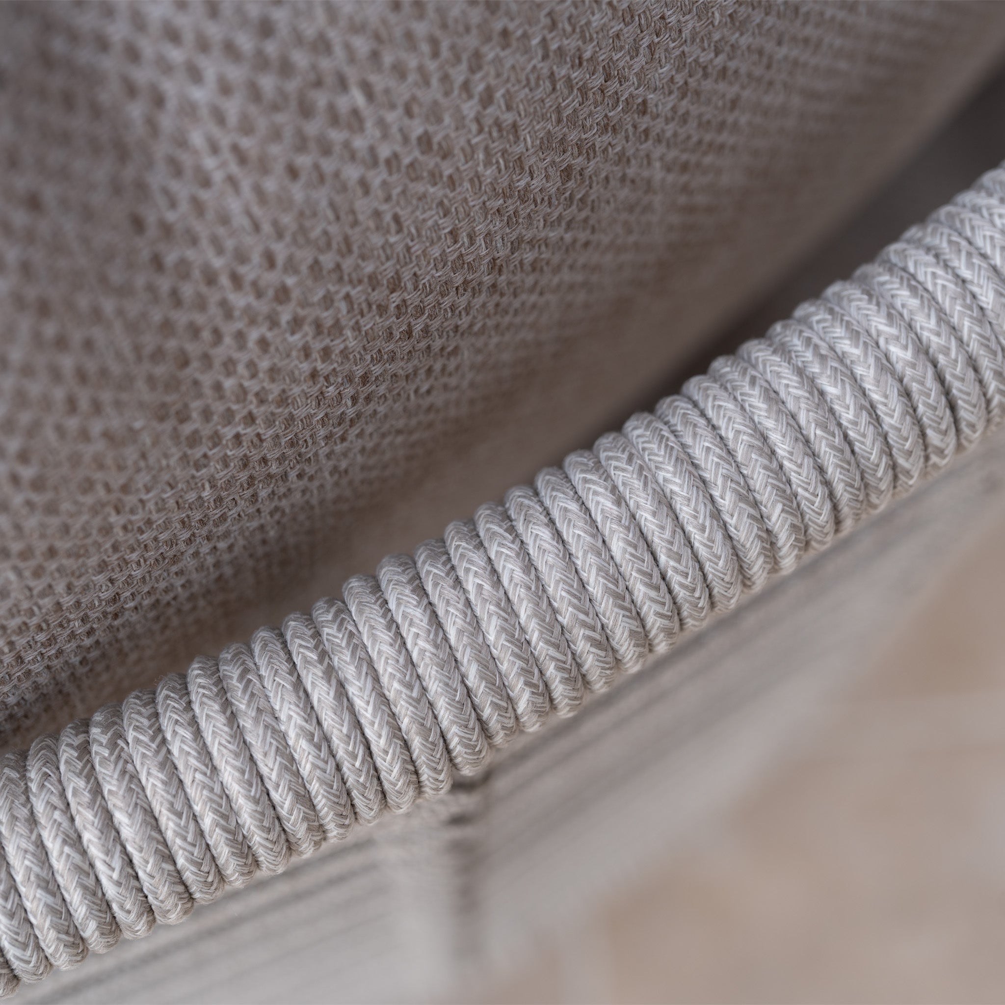 Close-up of the textured fabric backrest and tightly wound rope detail on the Sutera Curved Chaise Sofa Set with Armchair in Putty, highlighting its elegant outdoor garden furniture style.