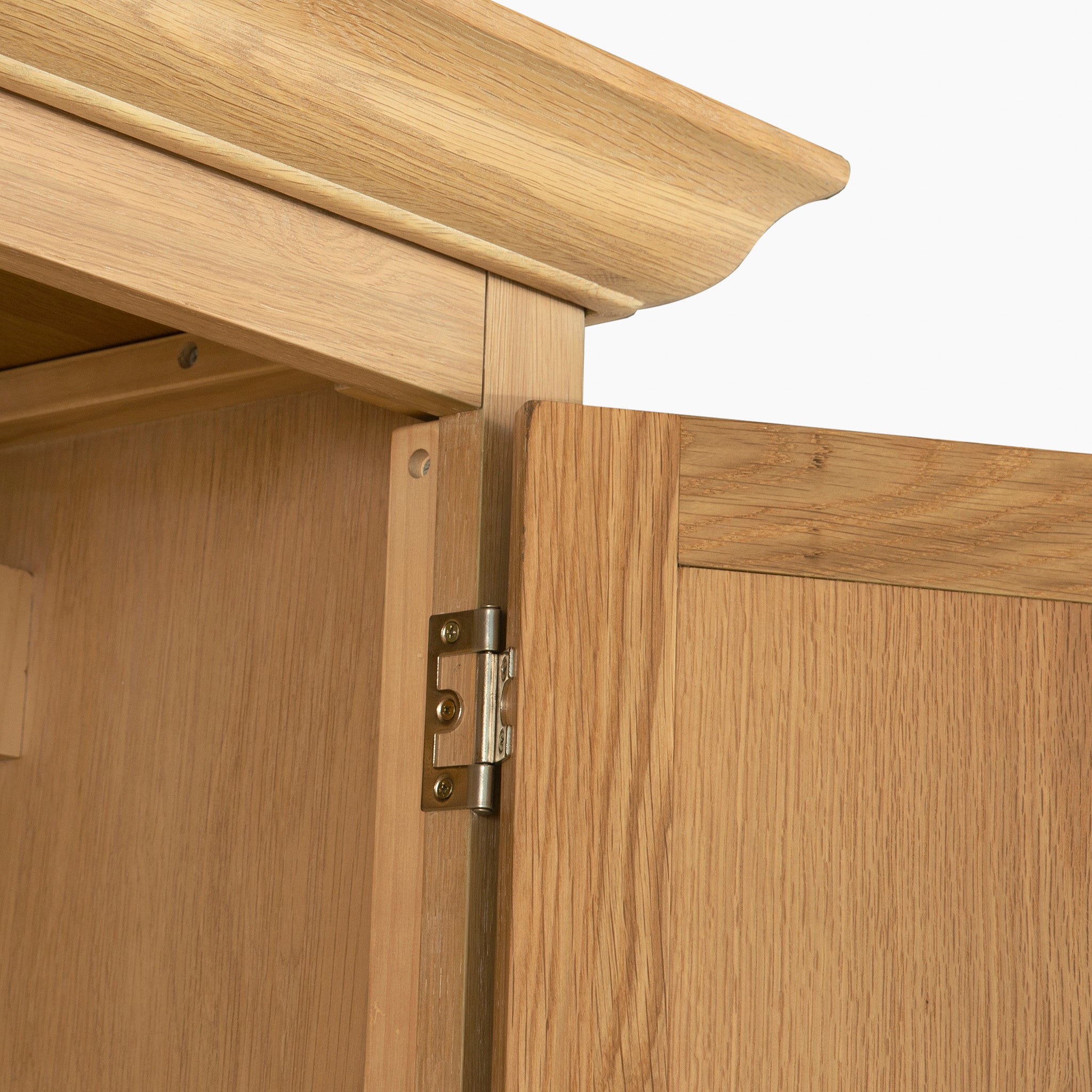 Close-up of the Amberley Double Wardrobe in Light Oak, showing a partially open hinged door with visible crown molding detail.