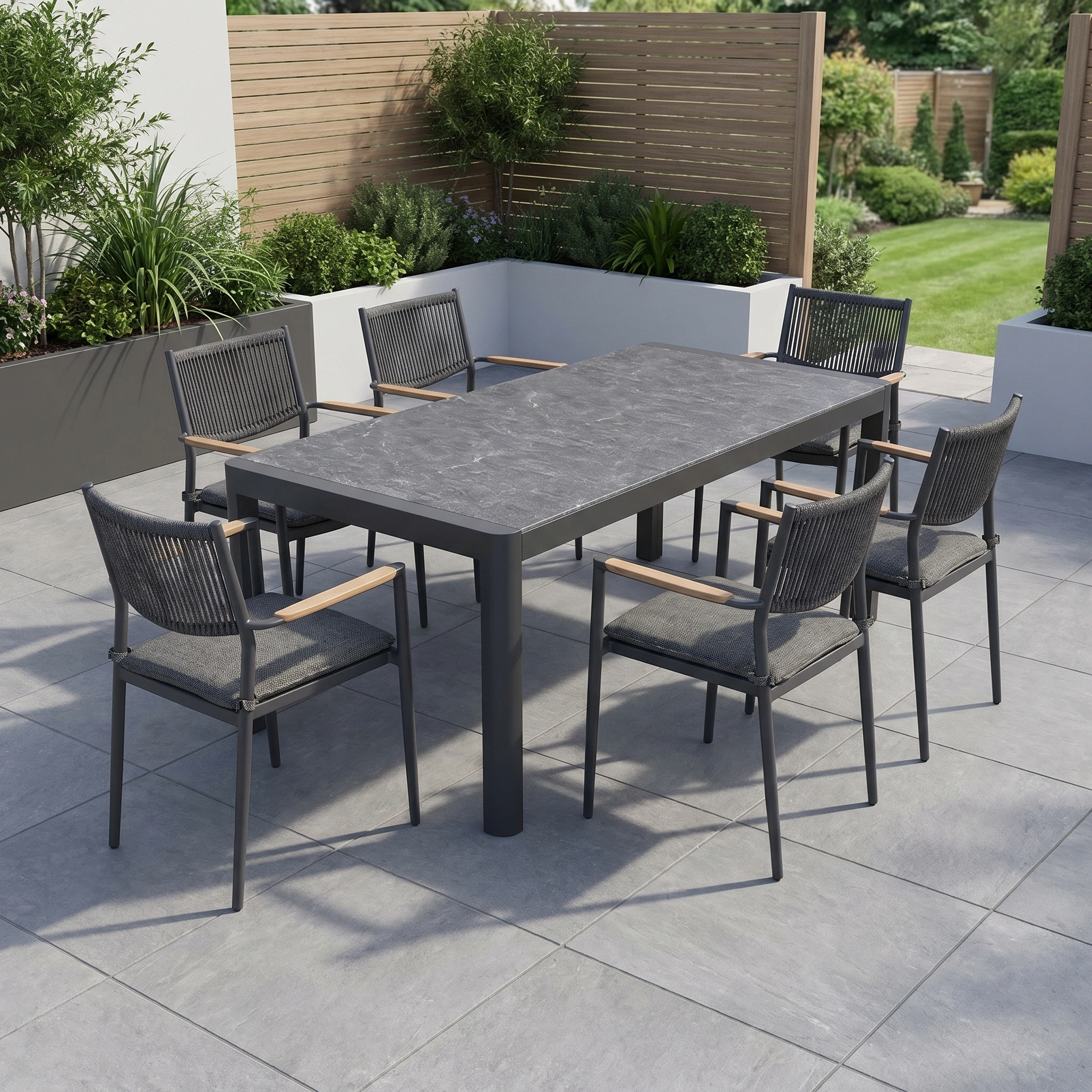 The Tellaro 6 Seat Extending Dining Set in Grey features six chairs arranged around a ceramic-top table, perfect for outdoor dining on a tiled patio surrounded by greenery.