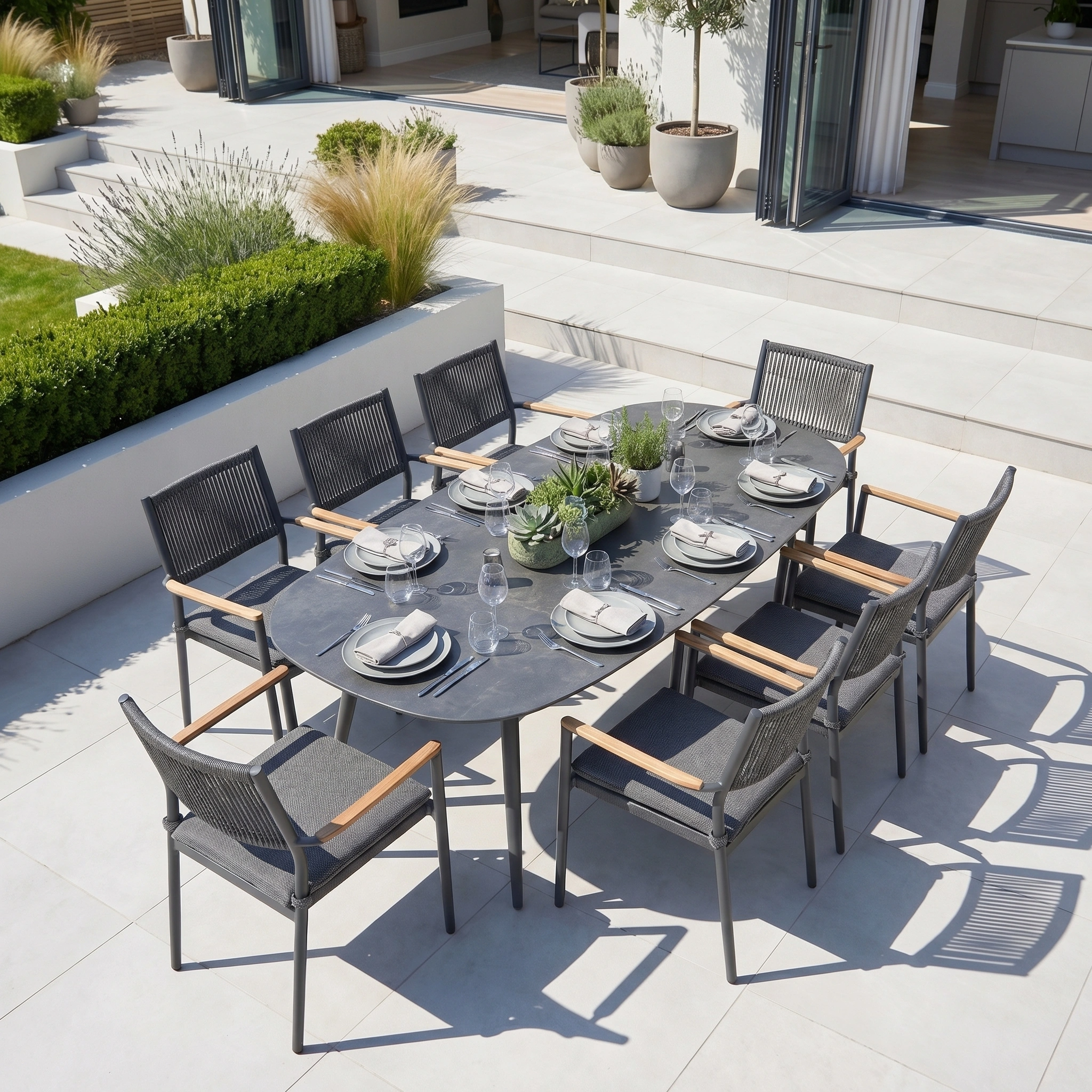 The Tellaro 8 Seat Oval Dining Set in Grey is a modern aluminium outdoor dining set, perfectly suited for sunny patios and gatherings.