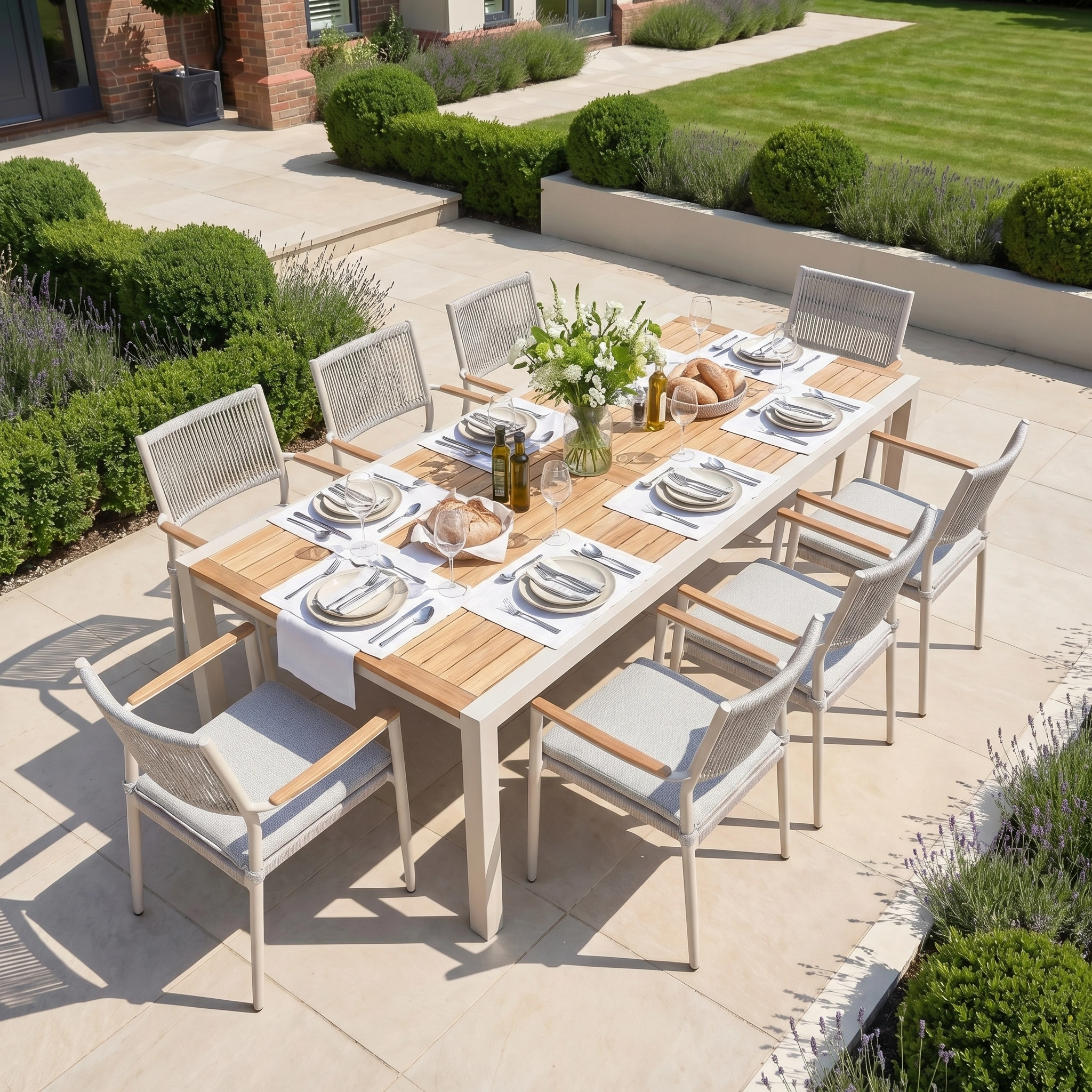 Tellaro 8 Seat Extending Dining Set with Teak Table in Latte, including a durable aluminium frame, looks stunning when placed amidst lush greenery and fragrant lavender.